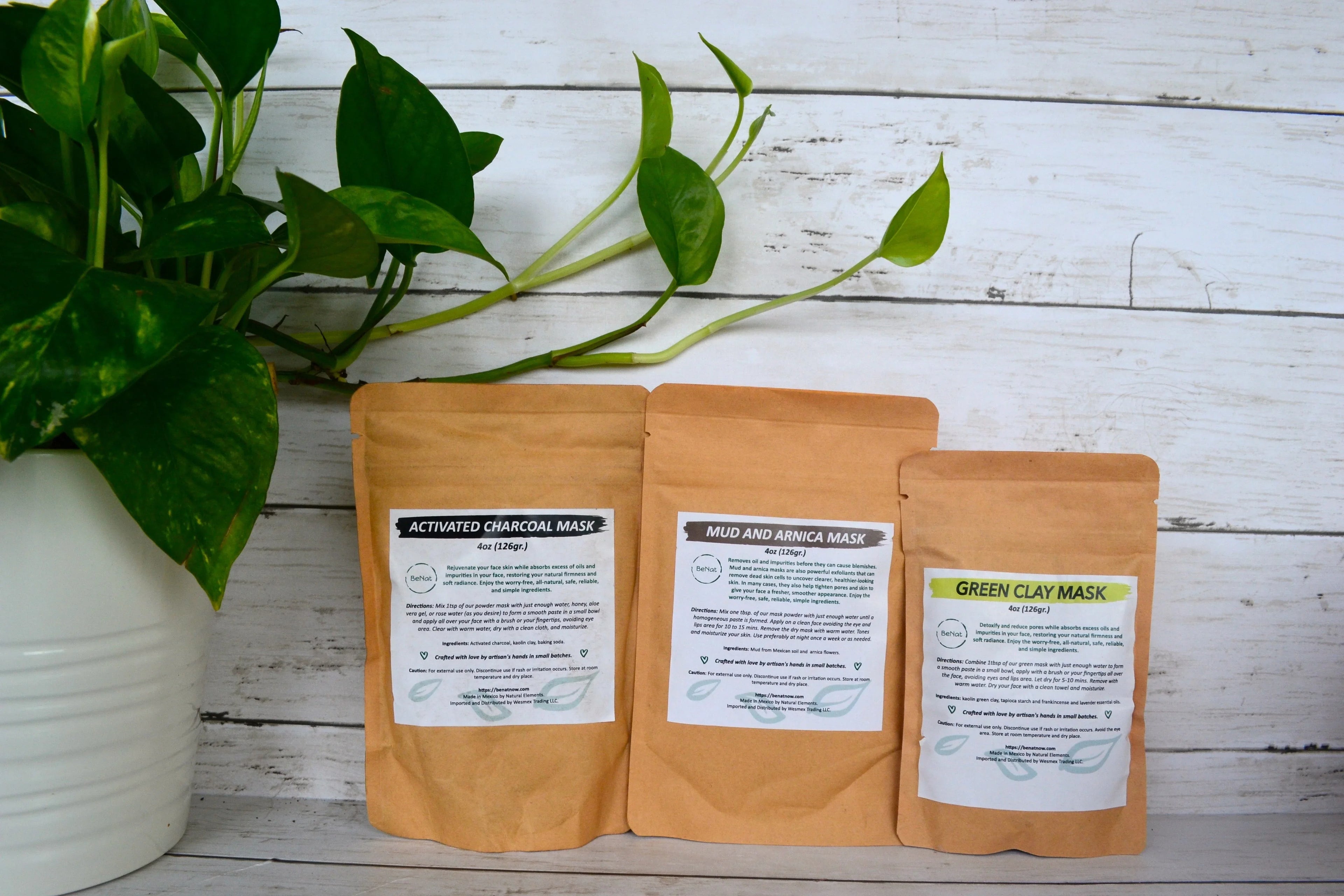 Natural facial masks in eco-friendly bags beside green plant on rustic wood, Qu!rk Boutique