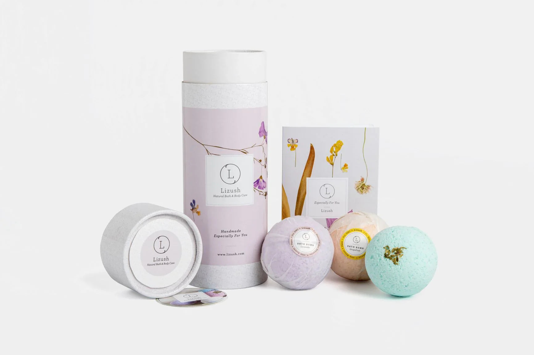 Lizush natural bath and body care set with bath bombs and floral packaging on white background