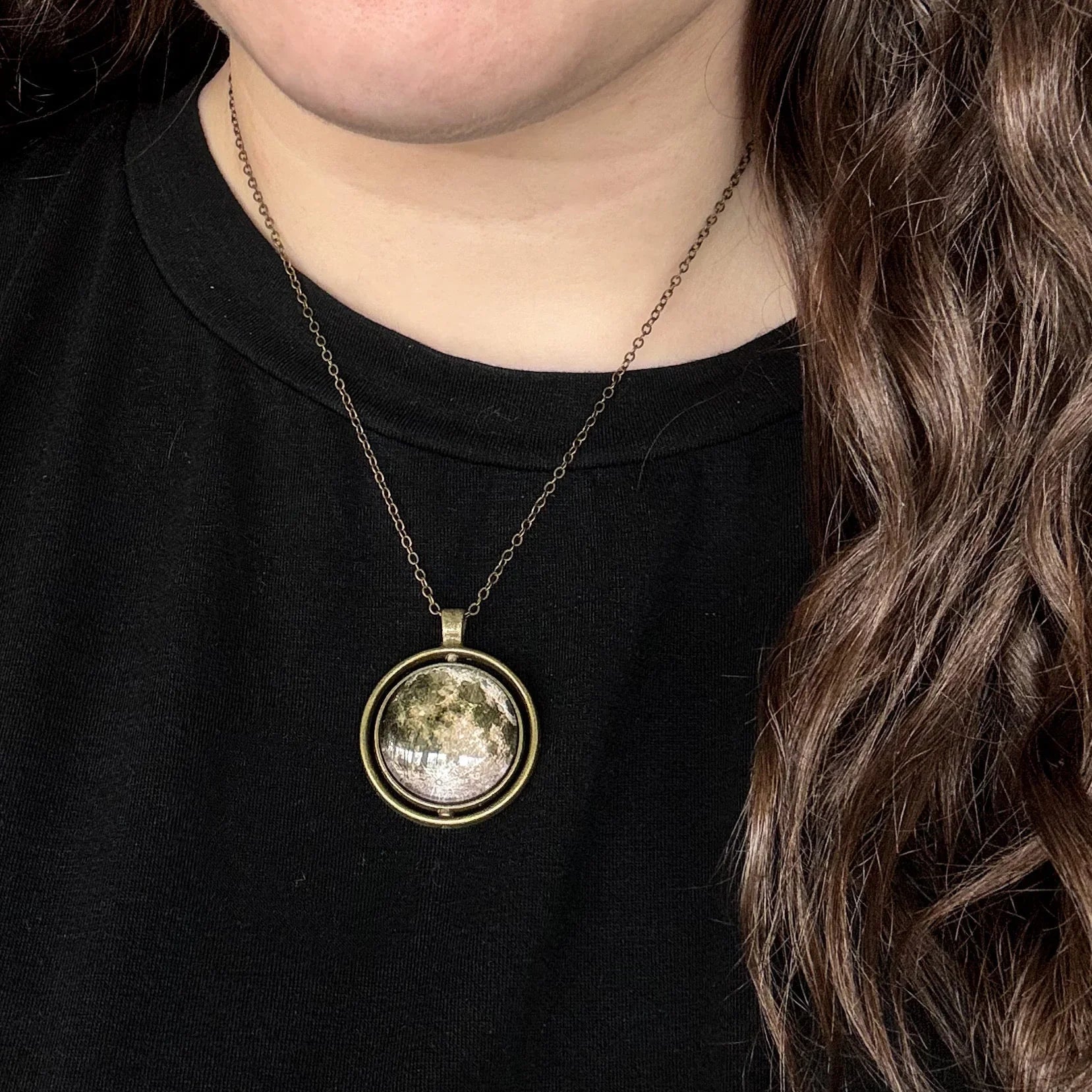 Woman wearing cosmic moon pendant necklace on bronze chain, Qu!rk Boutique jewelry style