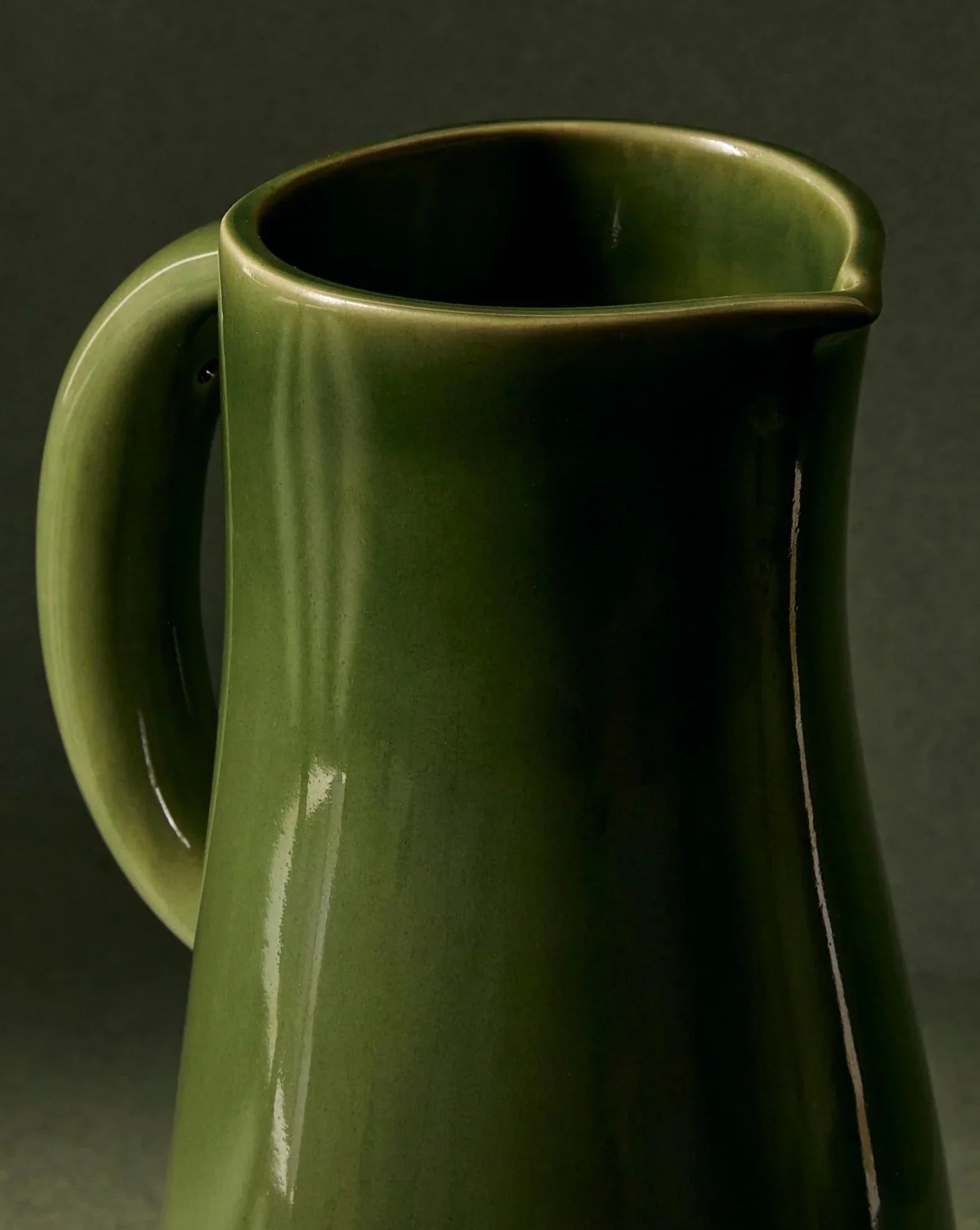 Glossy green ceramic pitcher with handle, artist-designed home decor at Qu!rk Boutique