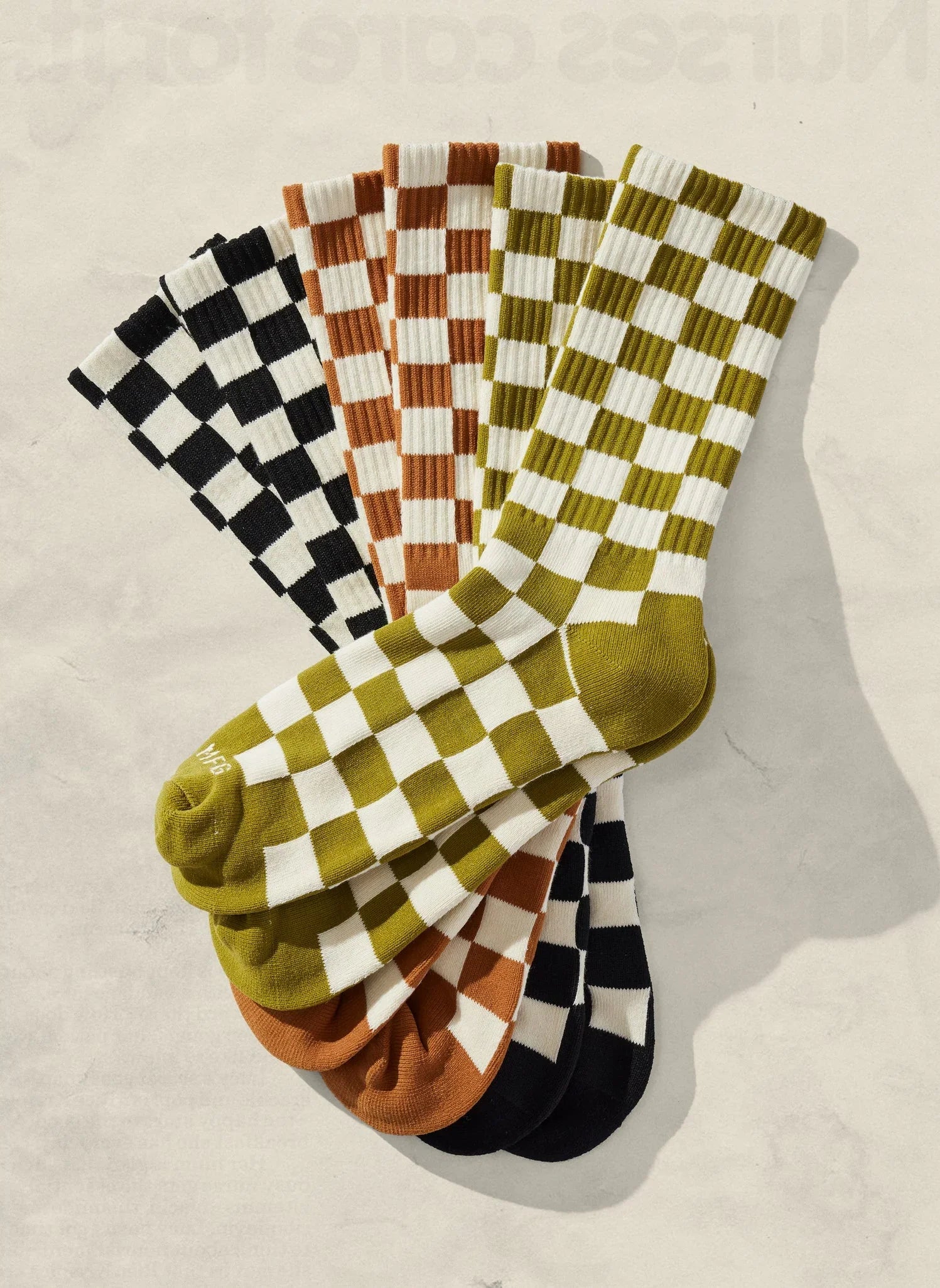 Artist-designed checkered socks in black, brown, and green from Qu!rk Boutique