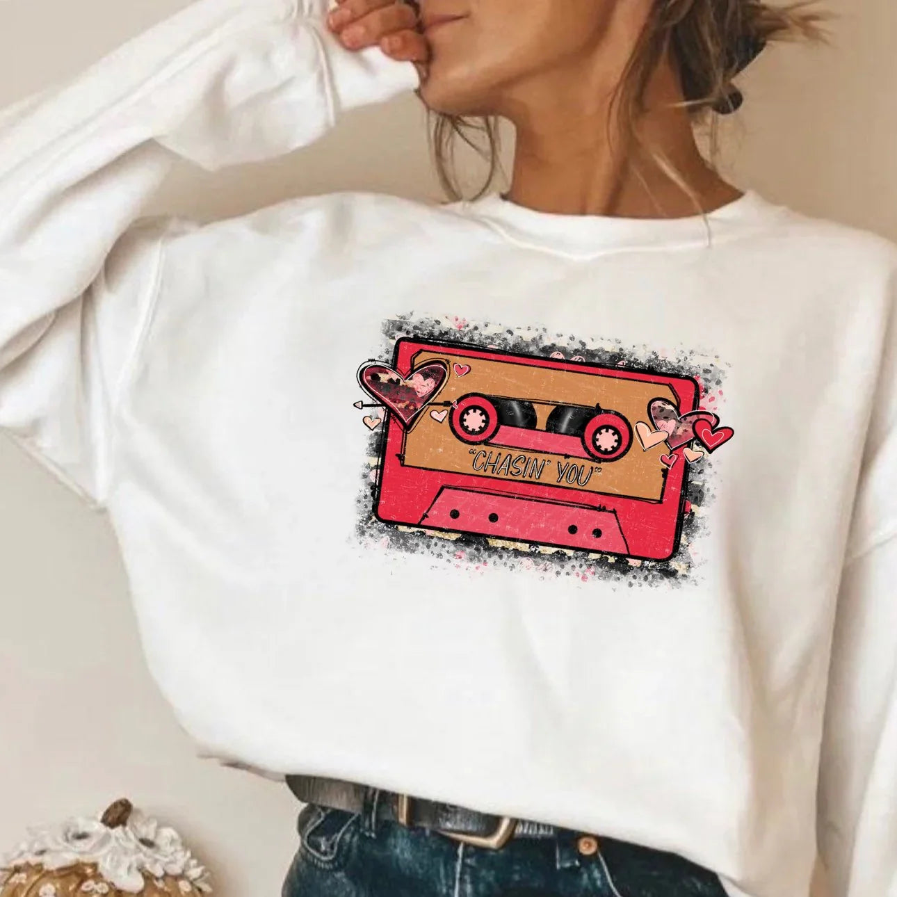 Woman wearing a white cosmic cassette tape sweatshirt from Qu!rk Boutique