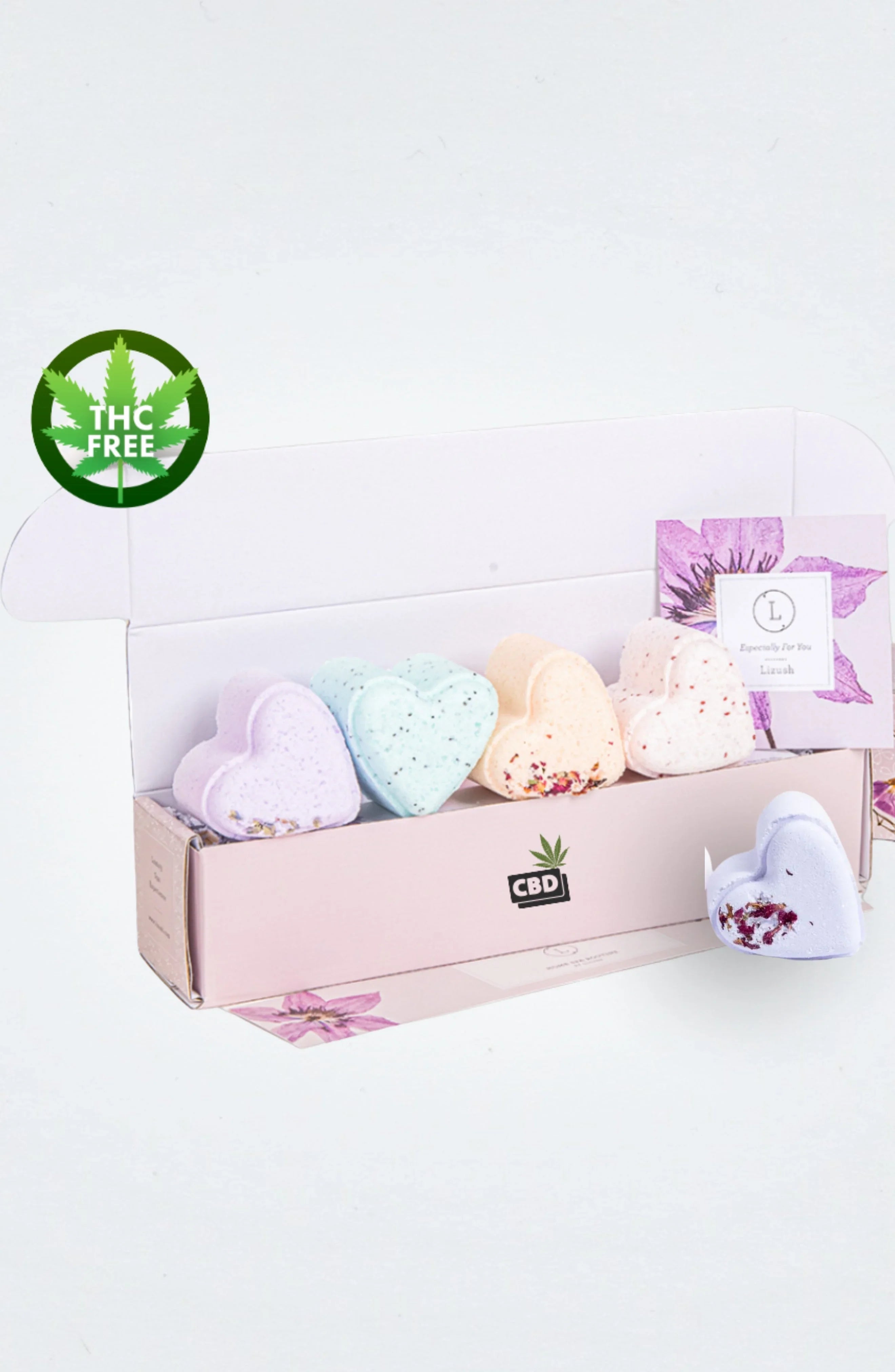 Box of colorful heart-shaped CBD bath bombs with THC-free label and floral packaging