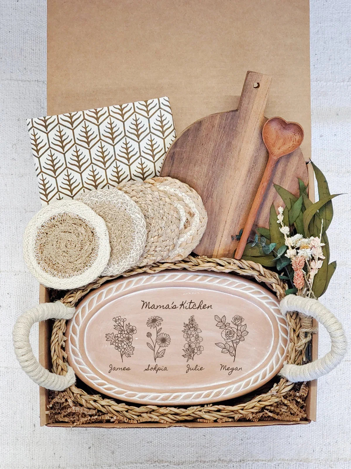 Personalized ceramic serving tray with floral designs and names, wooden cutting board, heart-shaped spoon, napkins, coasters, and dried flowers in gift box