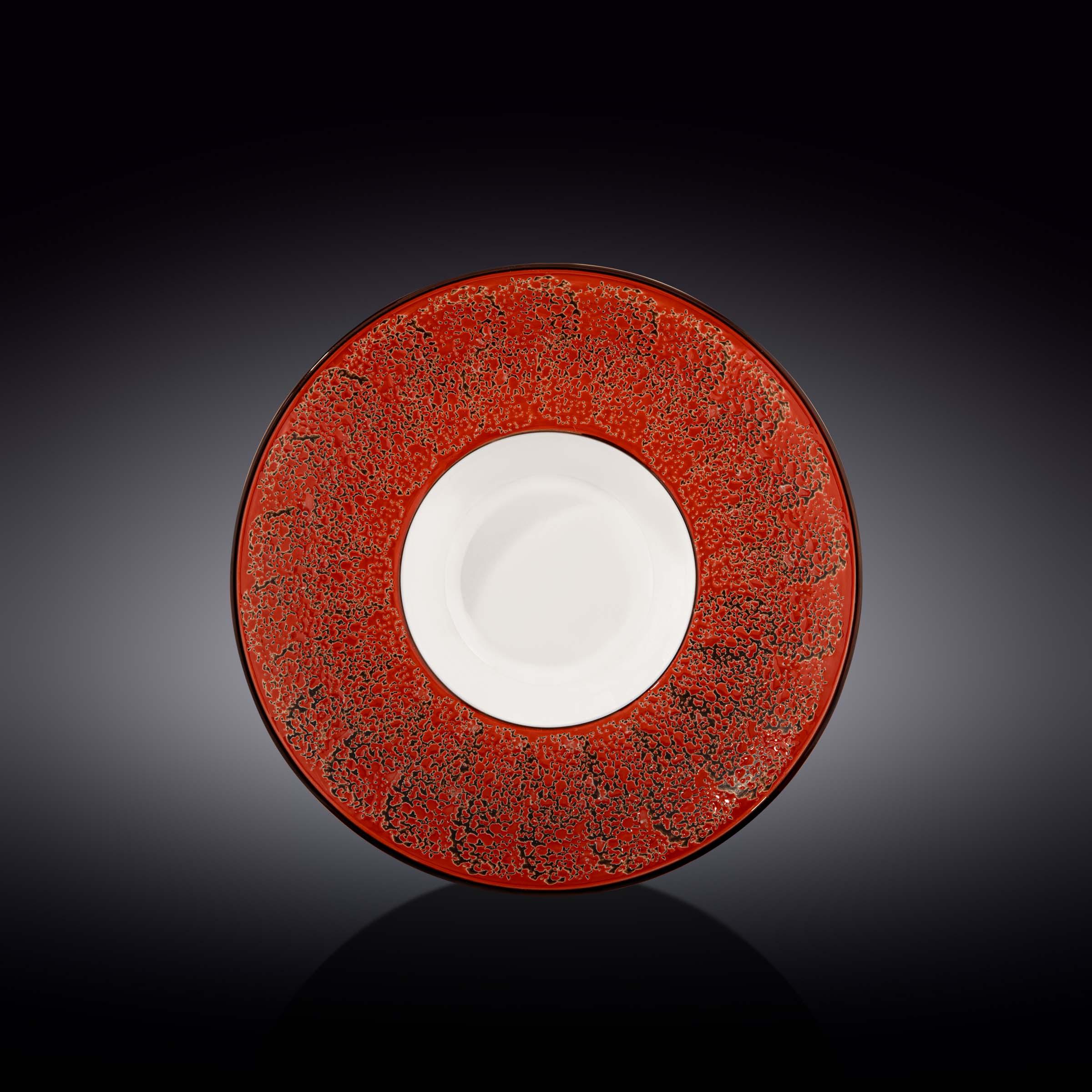 Artist-designed red and black ceramic plate with bold cosmic pattern on black background
