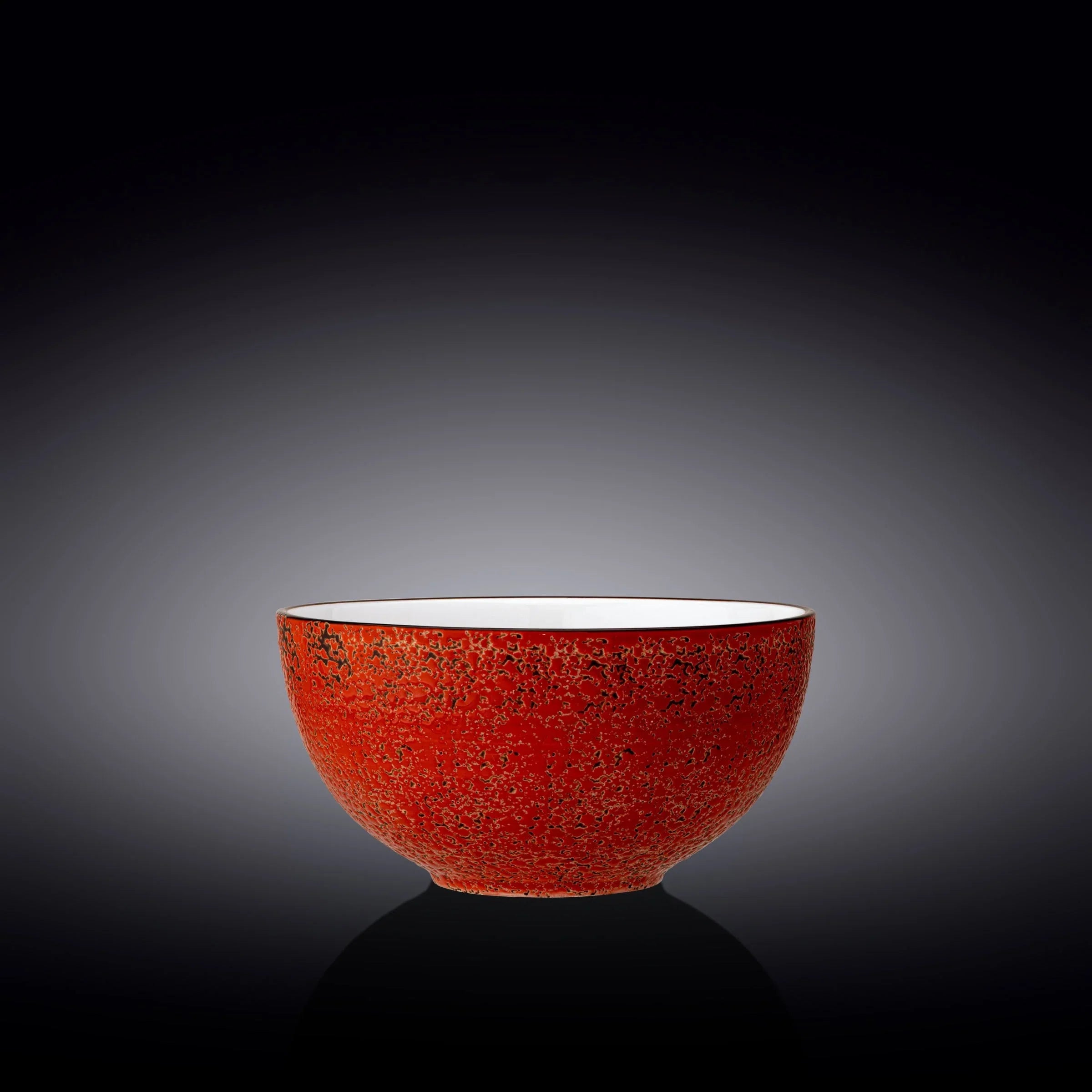 Handcrafted red ceramic bowl with black speckled pattern, cosmic-inspired home decor