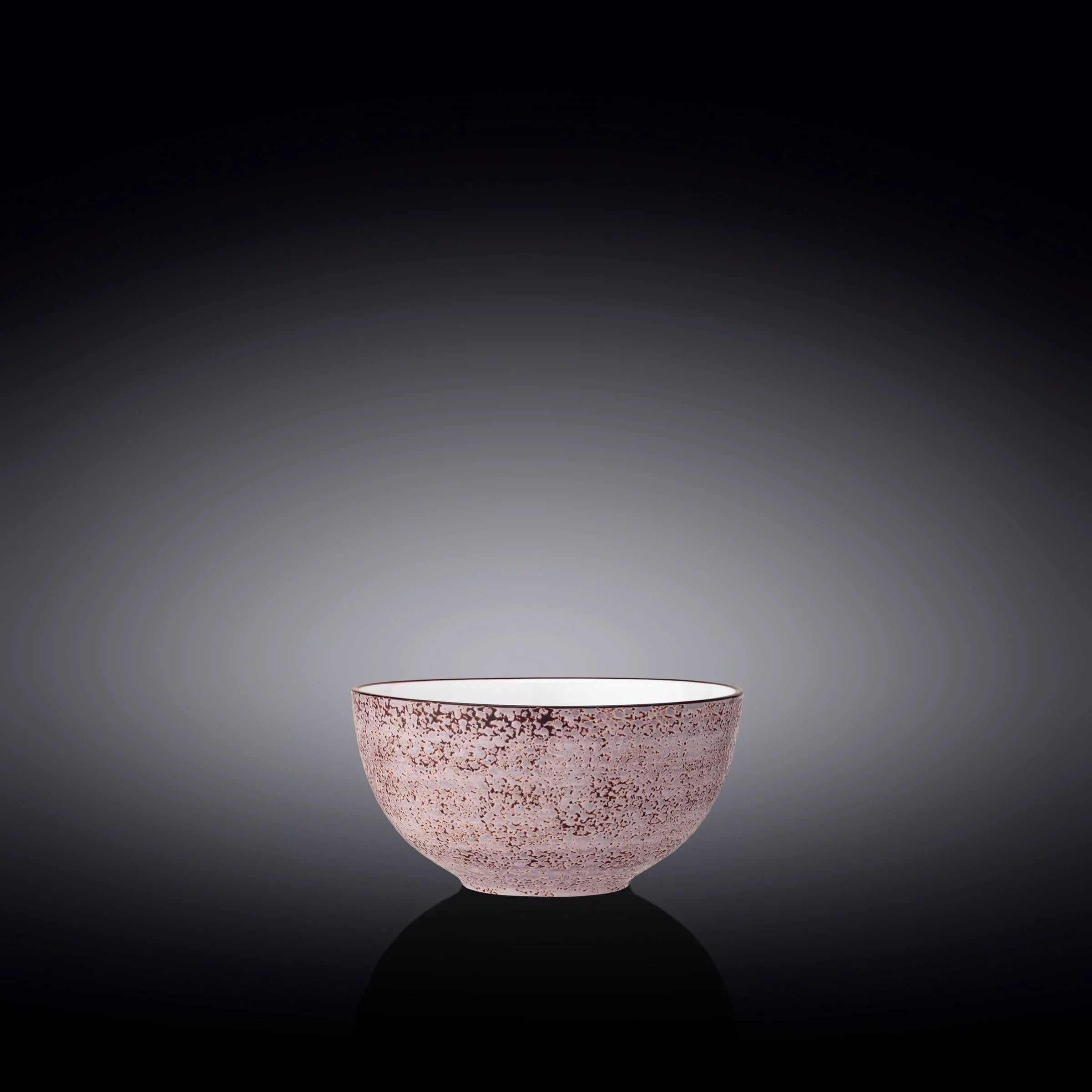 Pink speckled ceramic bowl on black reflective background, artist-designed home decor
