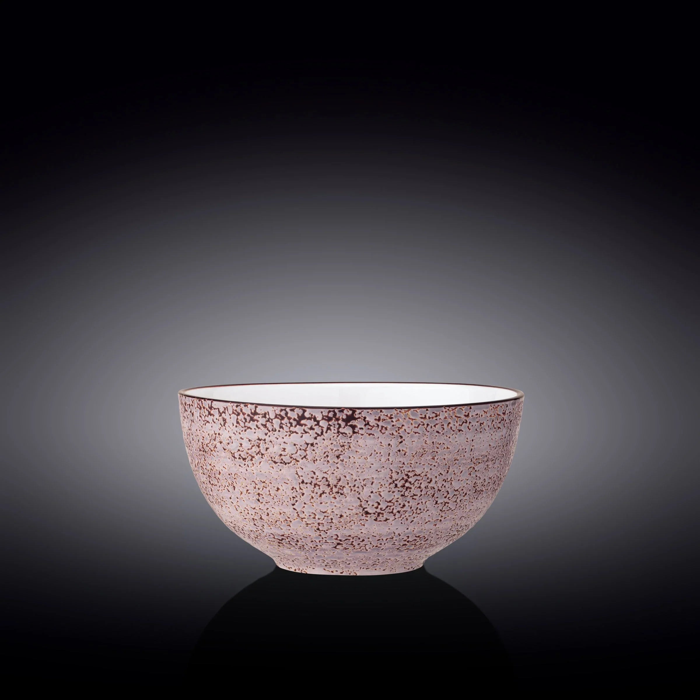 Pink textured ceramic bowl with speckled pattern on dark gradient background, Qu!rk Boutique