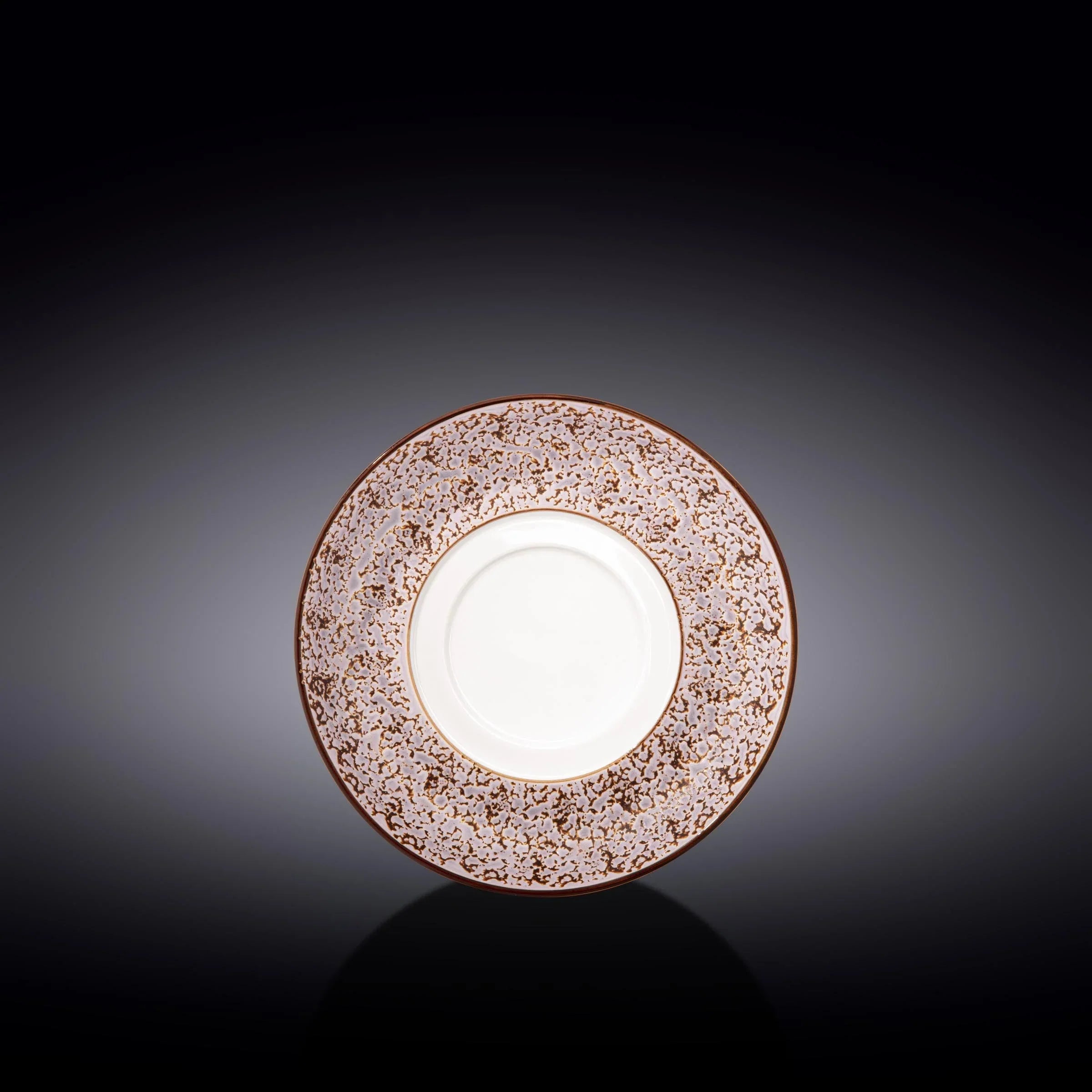 Ornate brown and white decorative plate with intricate pattern on dark background