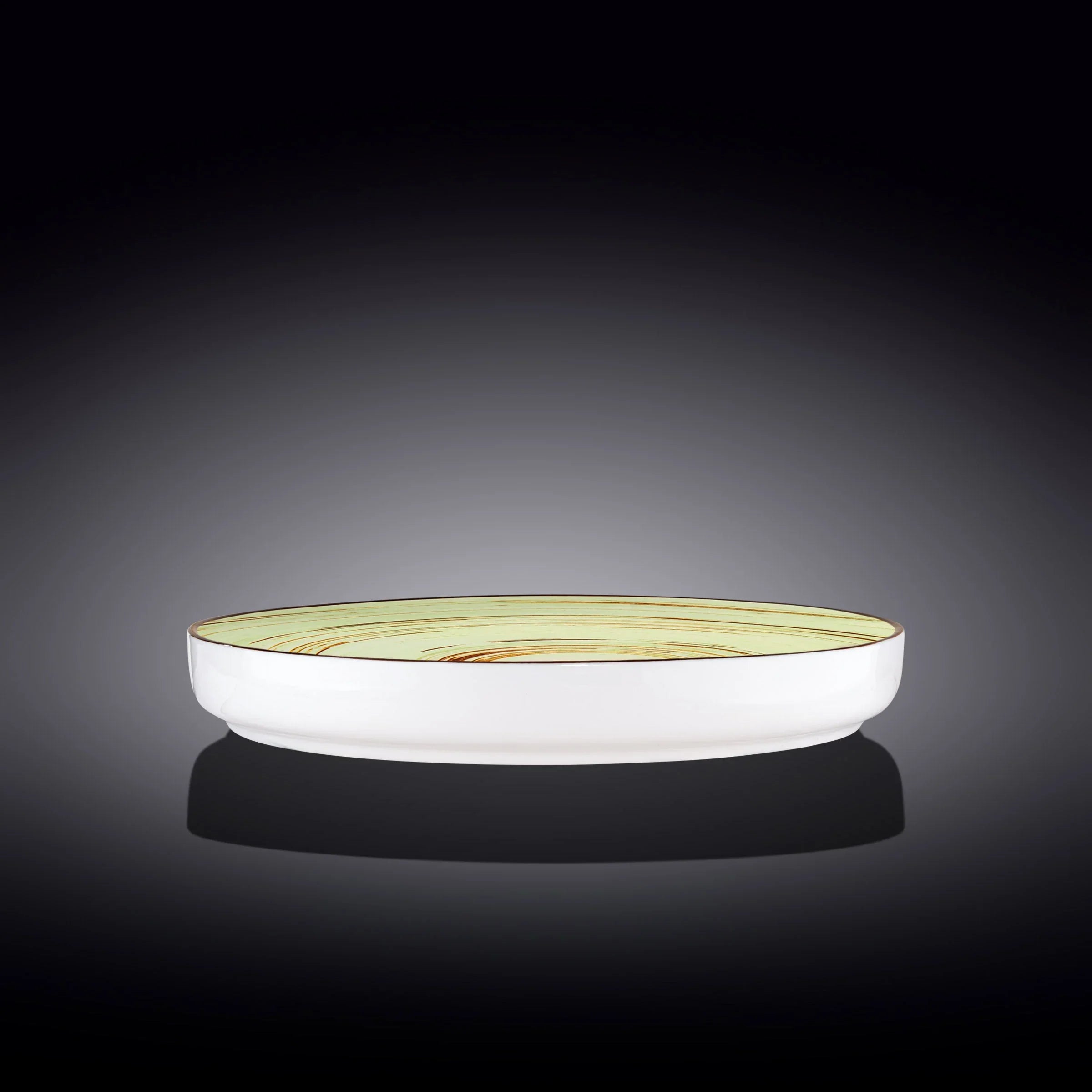 Modern ceramic bowl with pale yellow swirl design, artist-made, on dark background