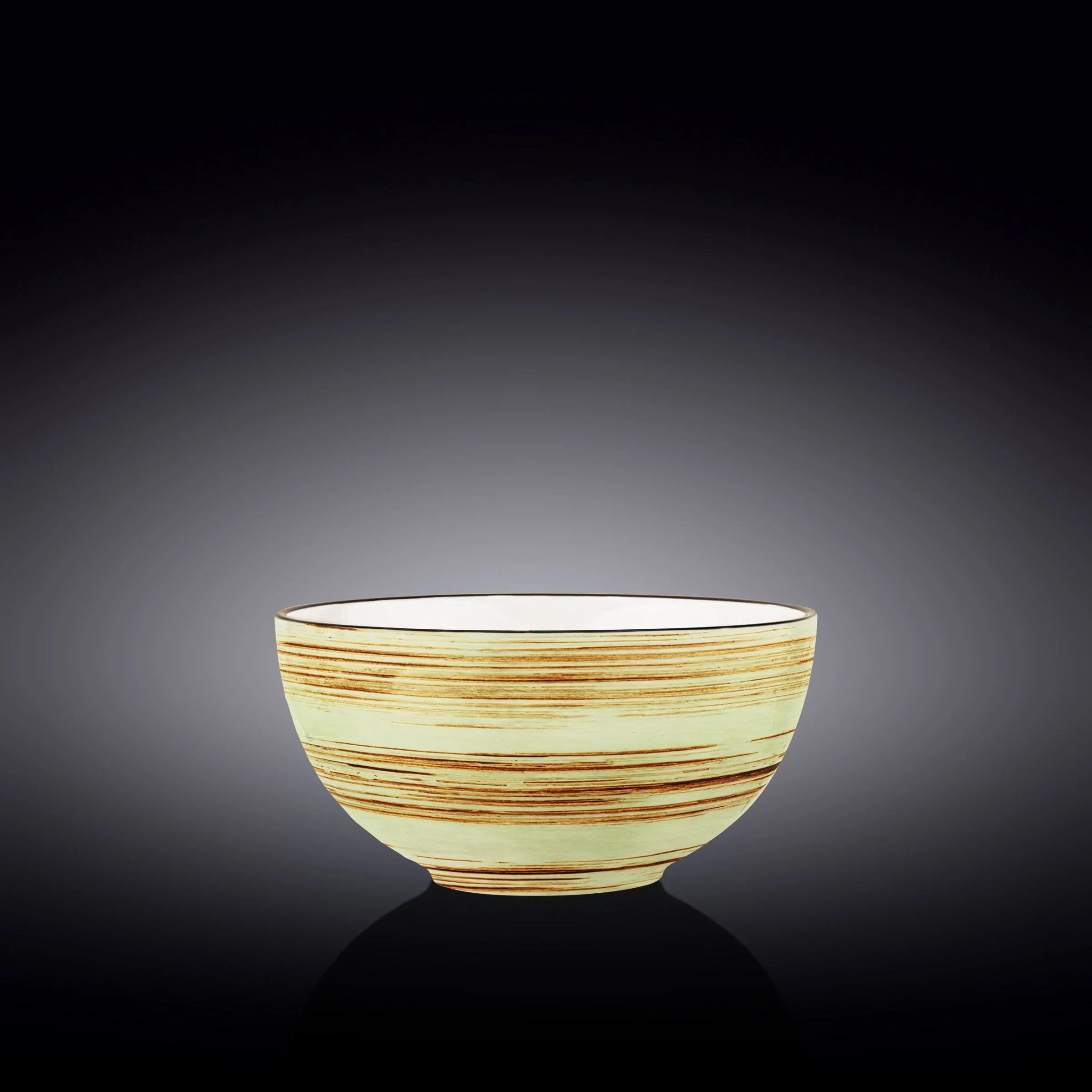 Handcrafted ceramic bowl with yellow and brown stripes by Qu!rk Boutique, on black background