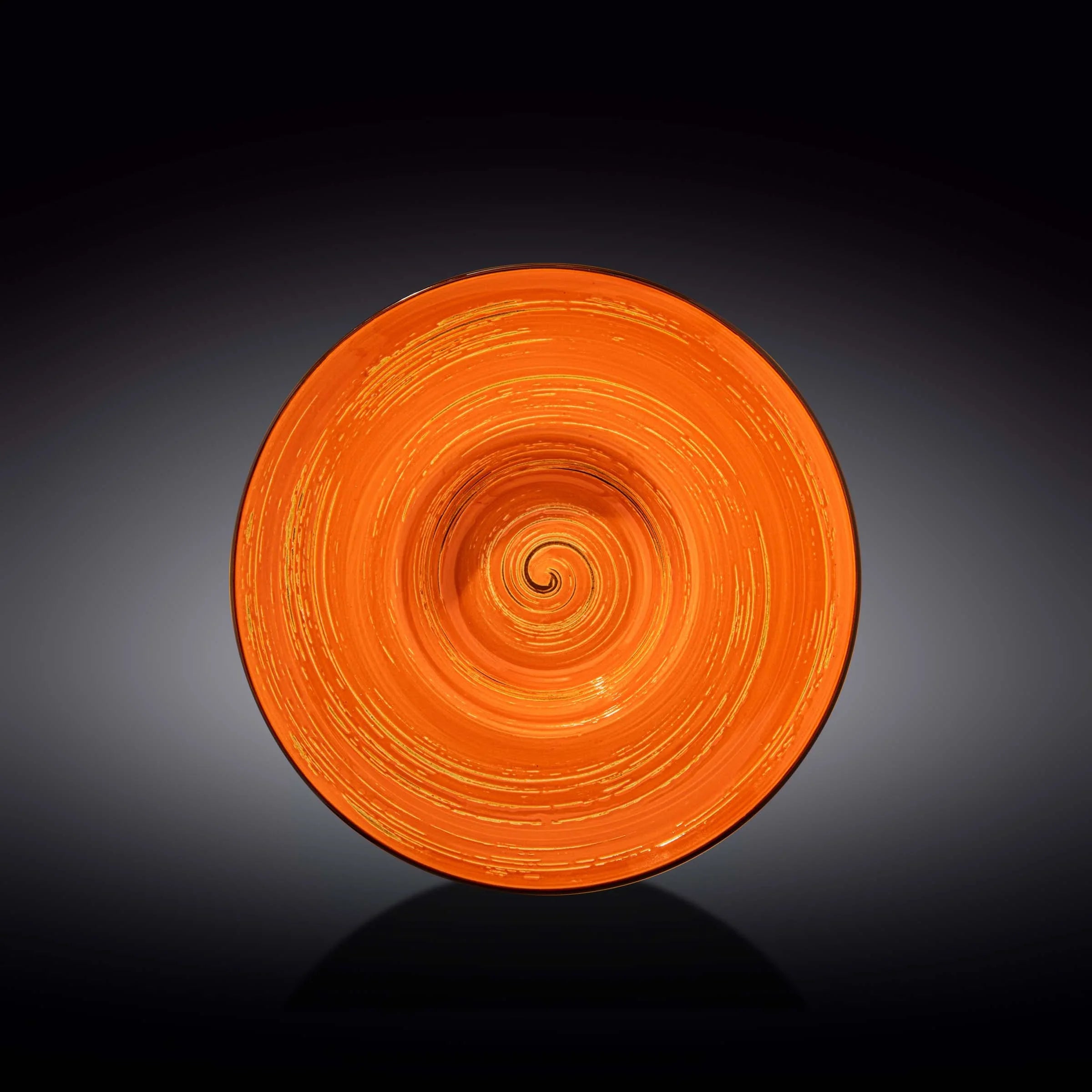 Vibrant orange spiral ceramic plate on black background, artist-designed décor at Qu!rk Boutique