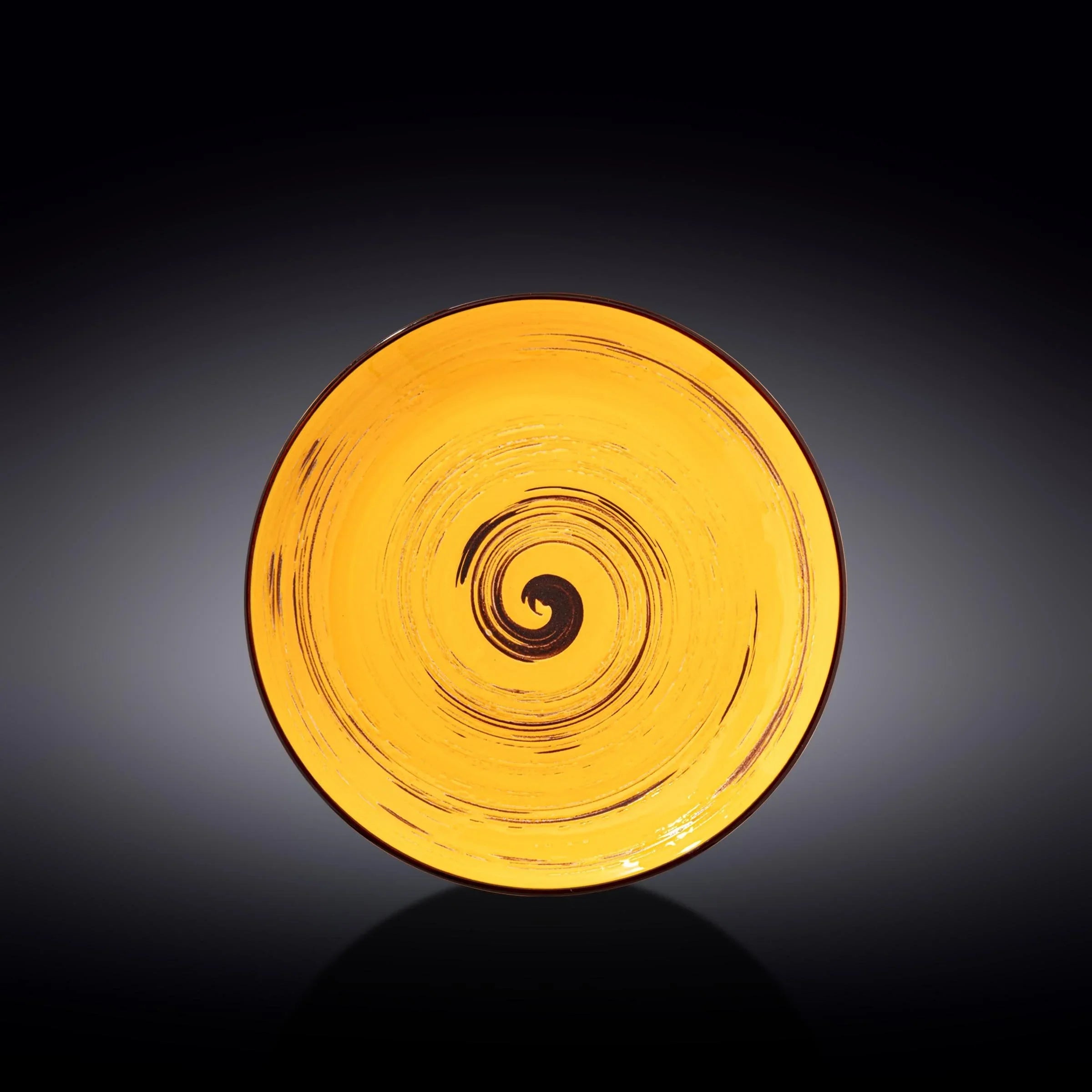 Yellow swirl ceramic plate on black background, artist-designed decor from Qu!rk Boutique