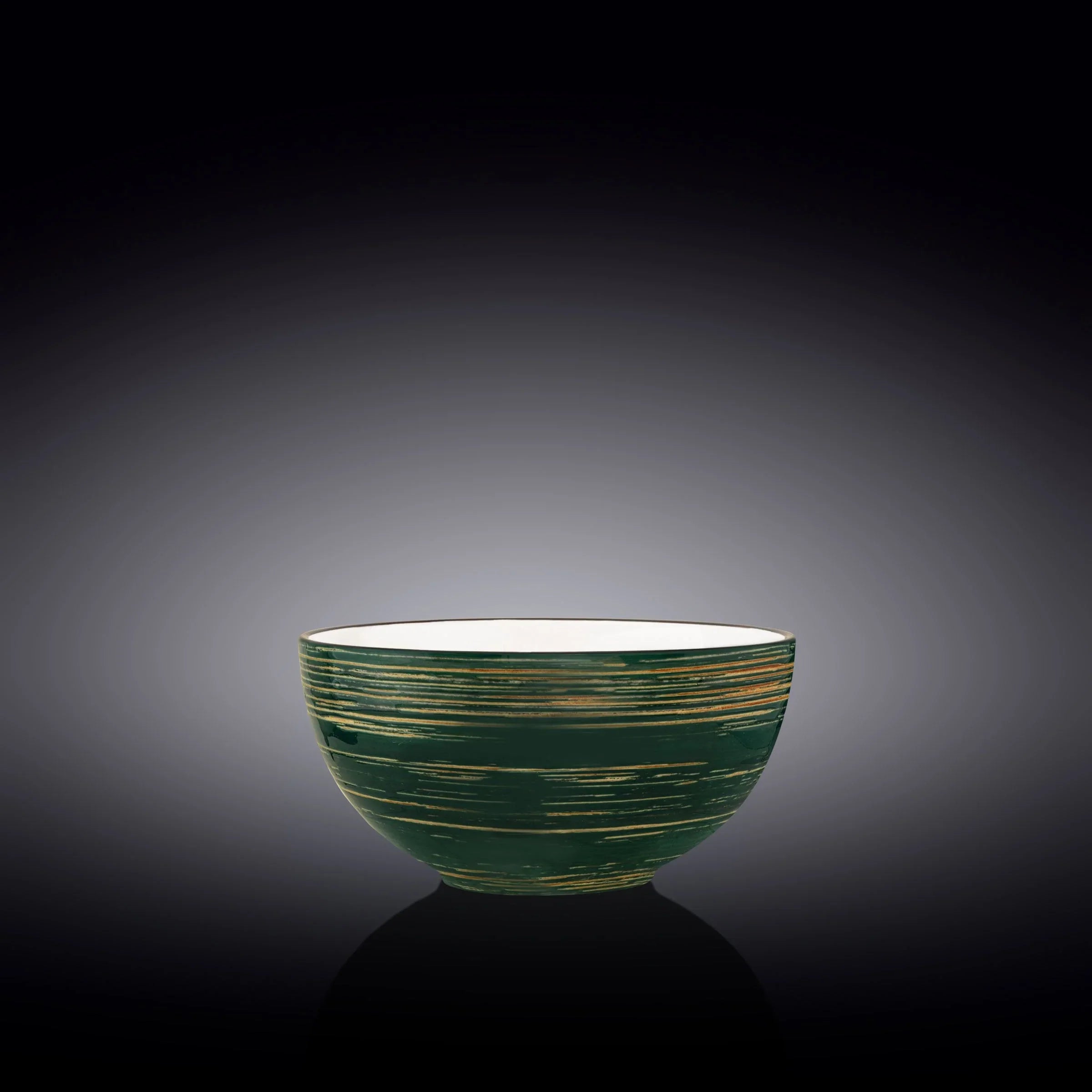 Handcrafted green and gold ceramic bowl, artist-designed, on a dark gradient background