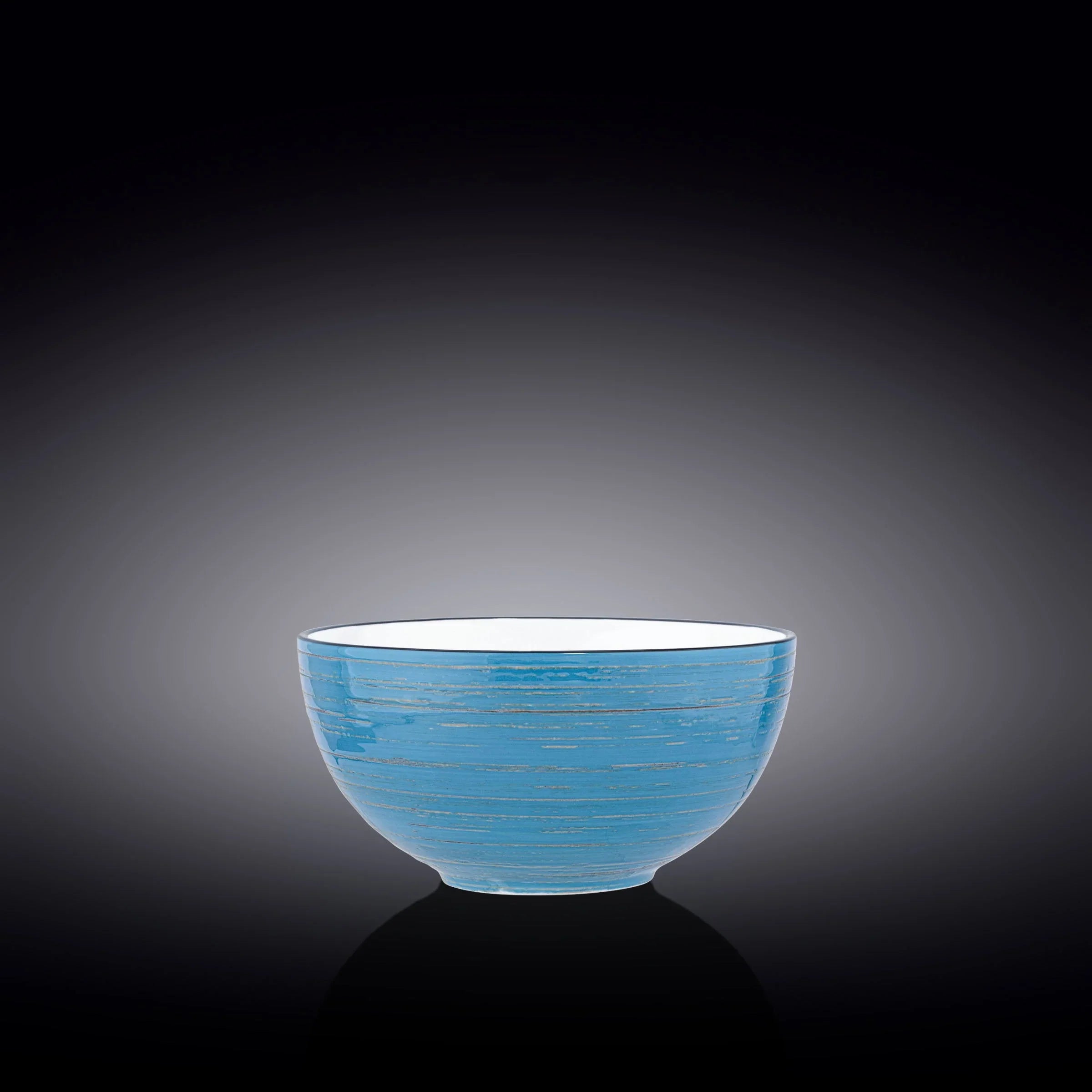 Artist-designed blue ceramic bowl with subtle lines, styled on a dark reflective background