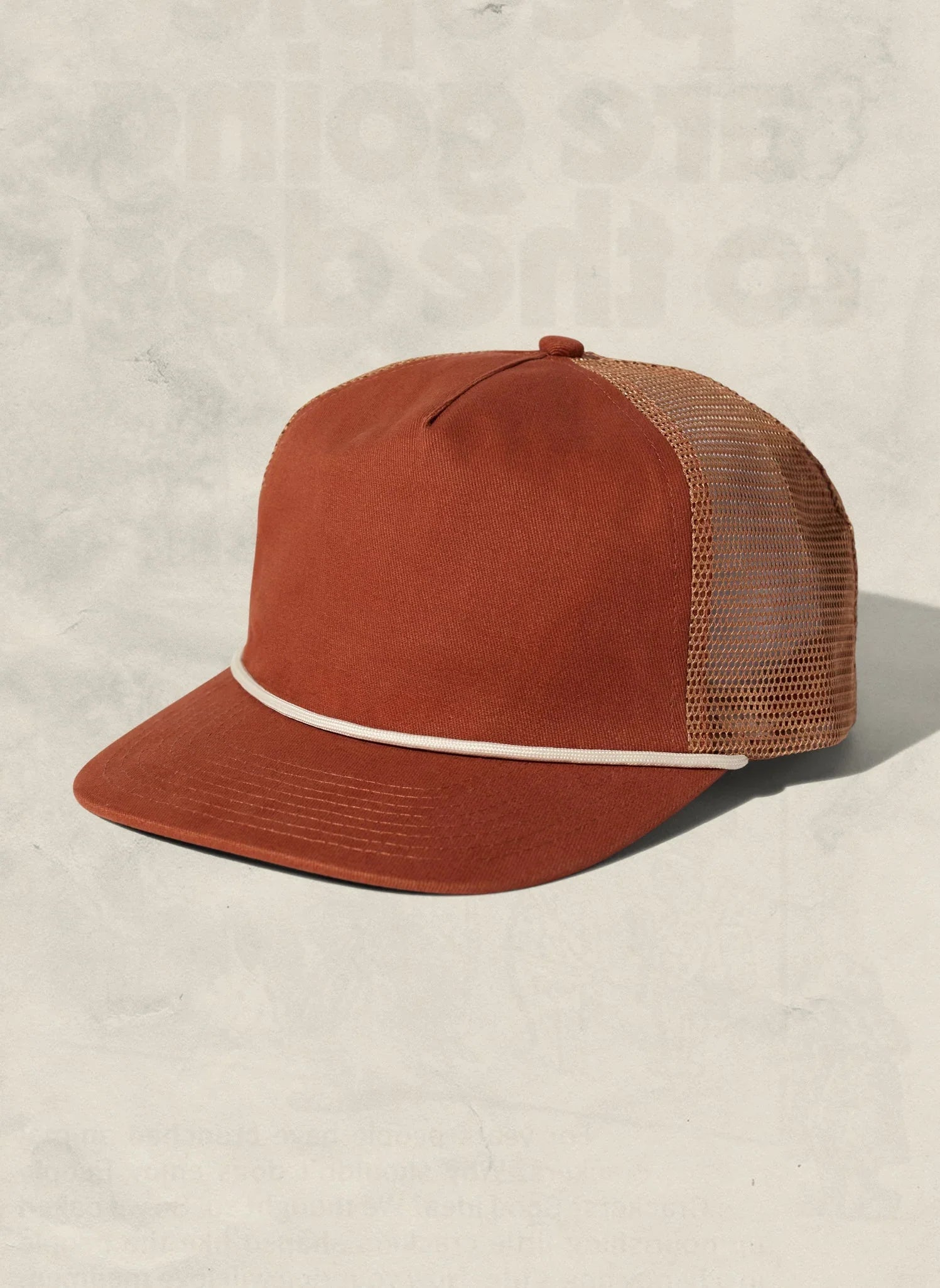 Rust orange mesh trucker hat with cream accent, artist-designed at Qu!rk Boutique