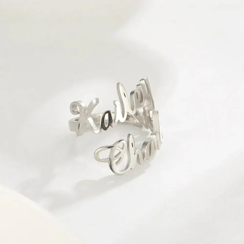 Silver personalized name ring with cursive script on white background