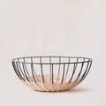 Modern wire and woven basket on neutral background, Qu!rk Boutique eco-friendly home decor