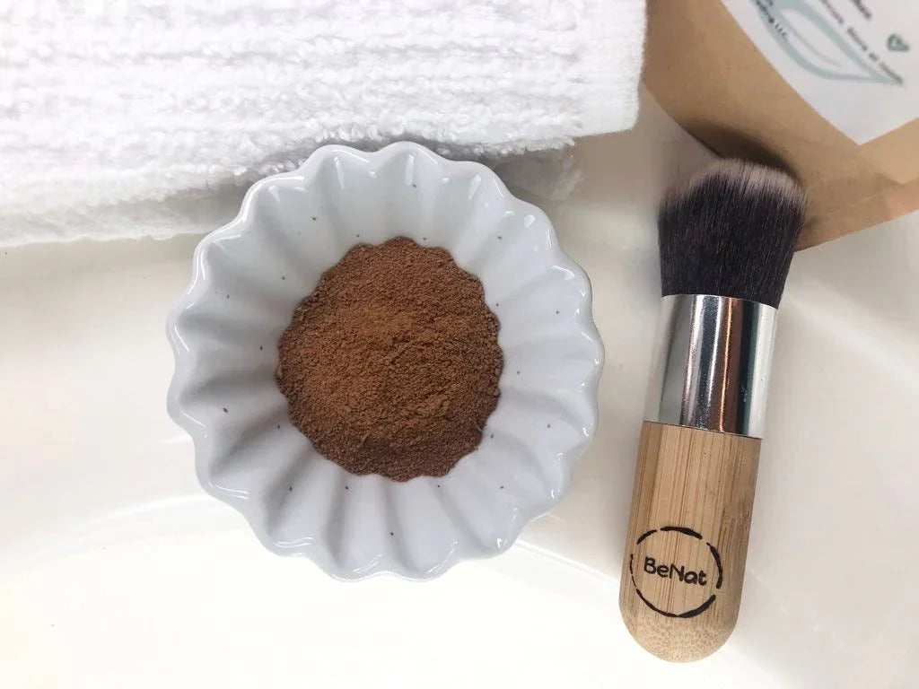 Natural cosmetic powder in a white bowl with eco-friendly brush and soft towel, Qu!rk Boutique