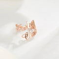 Rose gold custom name ring with cursive script on white surface