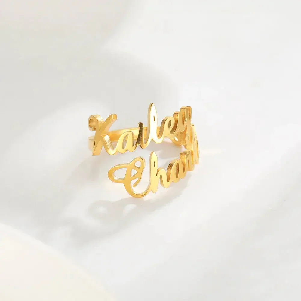 Gold custom name ring with script font on white background, personalized jewelry