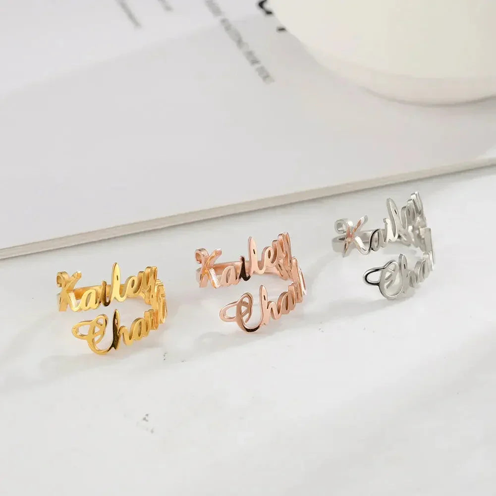 Three custom name rings in gold, rose gold, and silver spelling Karley Chant on white surface