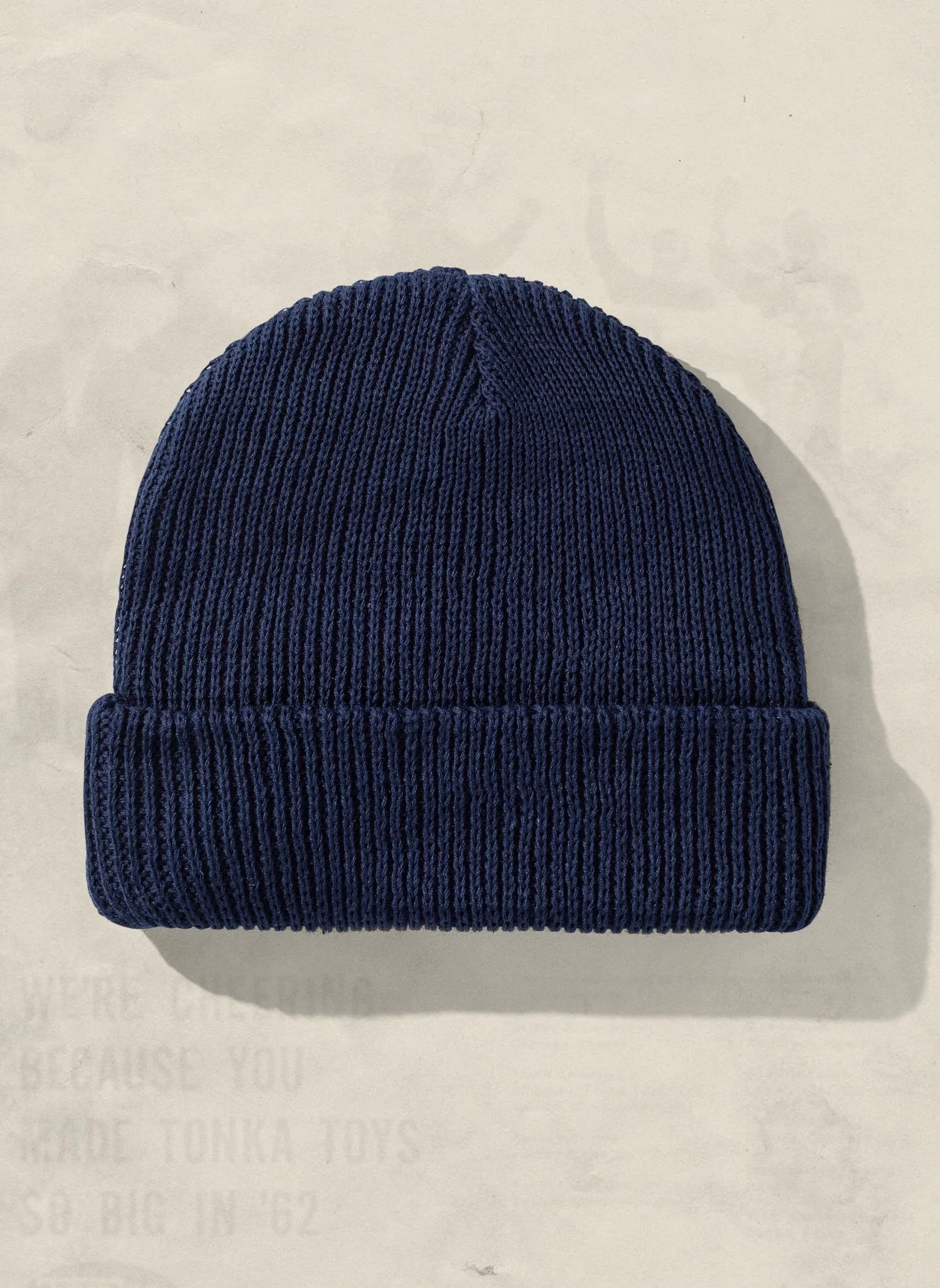 Navy blue knit beanie hat on neutral background from Qu!rk Boutique.