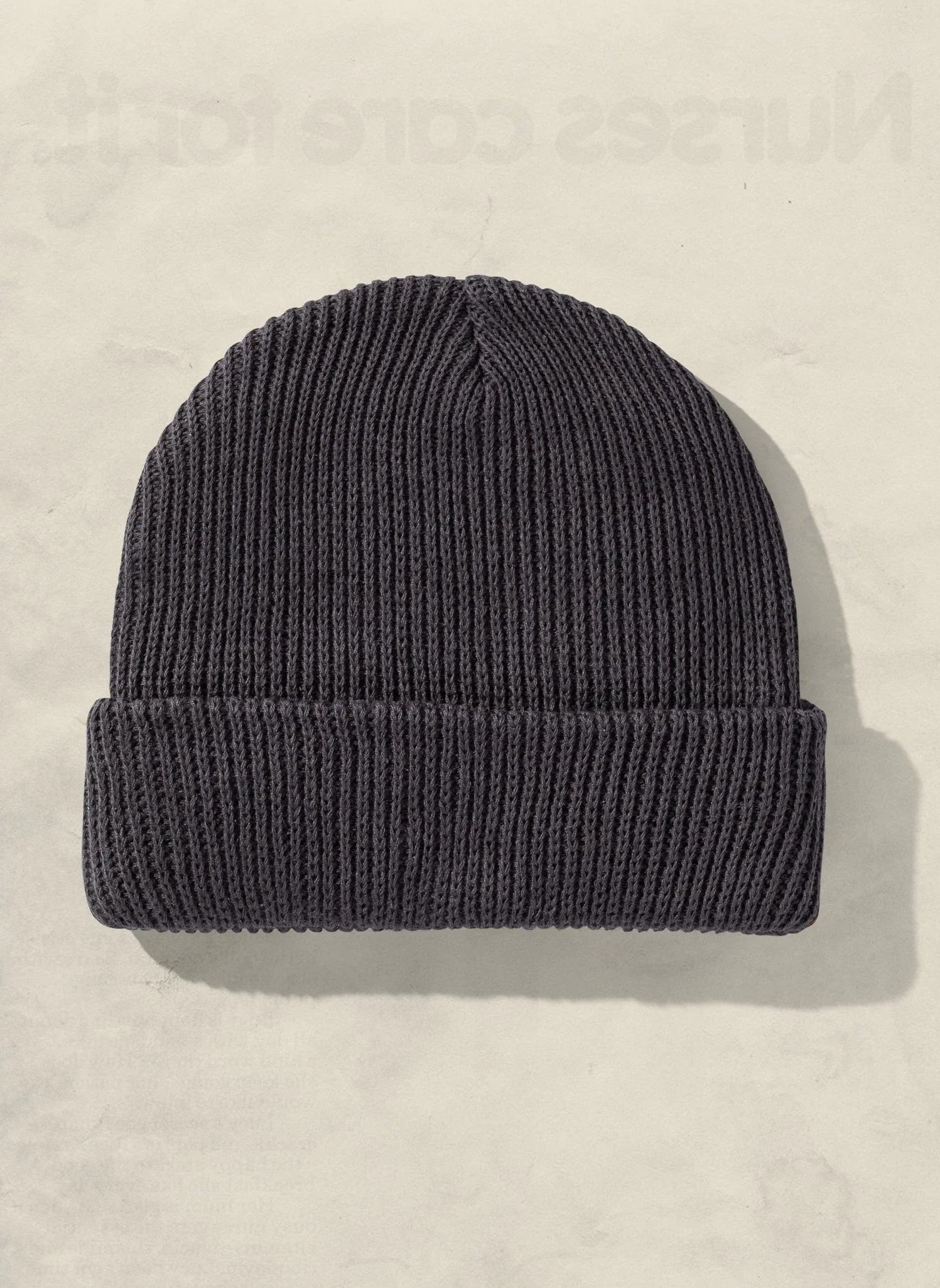 Black ribbed knit beanie hat displayed on a light background, Qu!rk boutique winter accessory