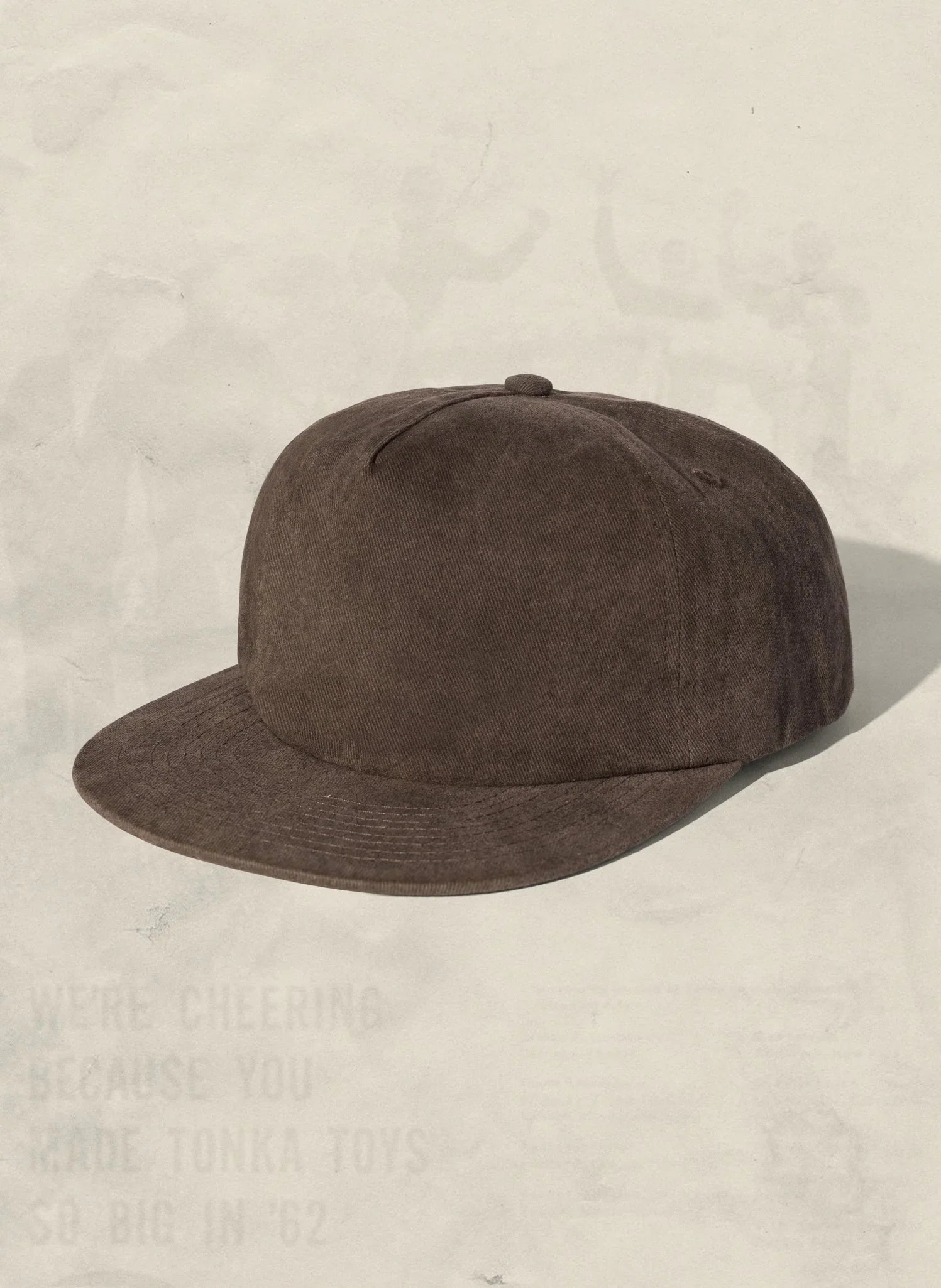 Brown corduroy baseball cap with flat brim on neutral background from Qu!rk Boutique