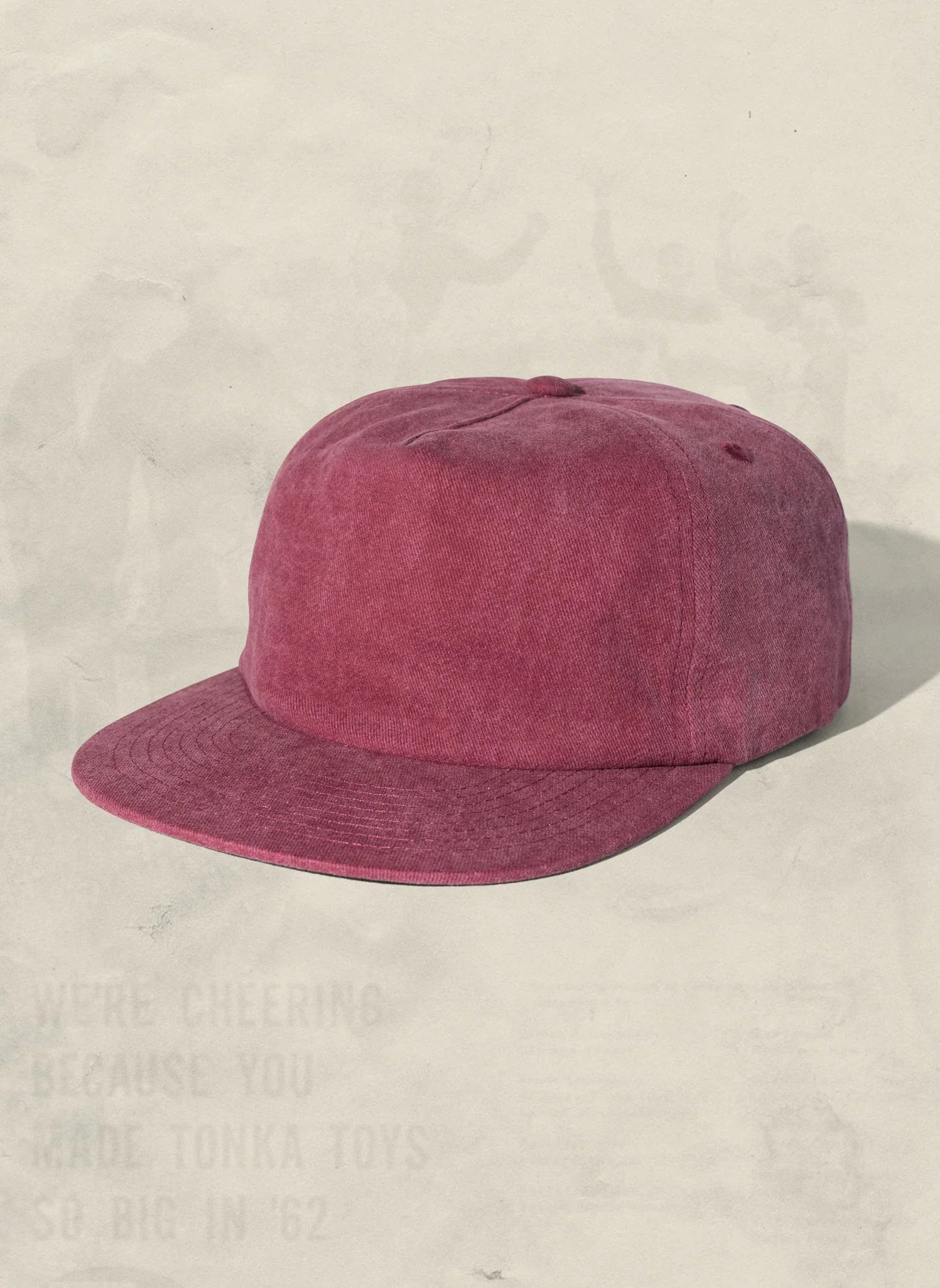Burgundy corduroy baseball cap on neutral background, Qu!rk Boutique artist-designed accessory