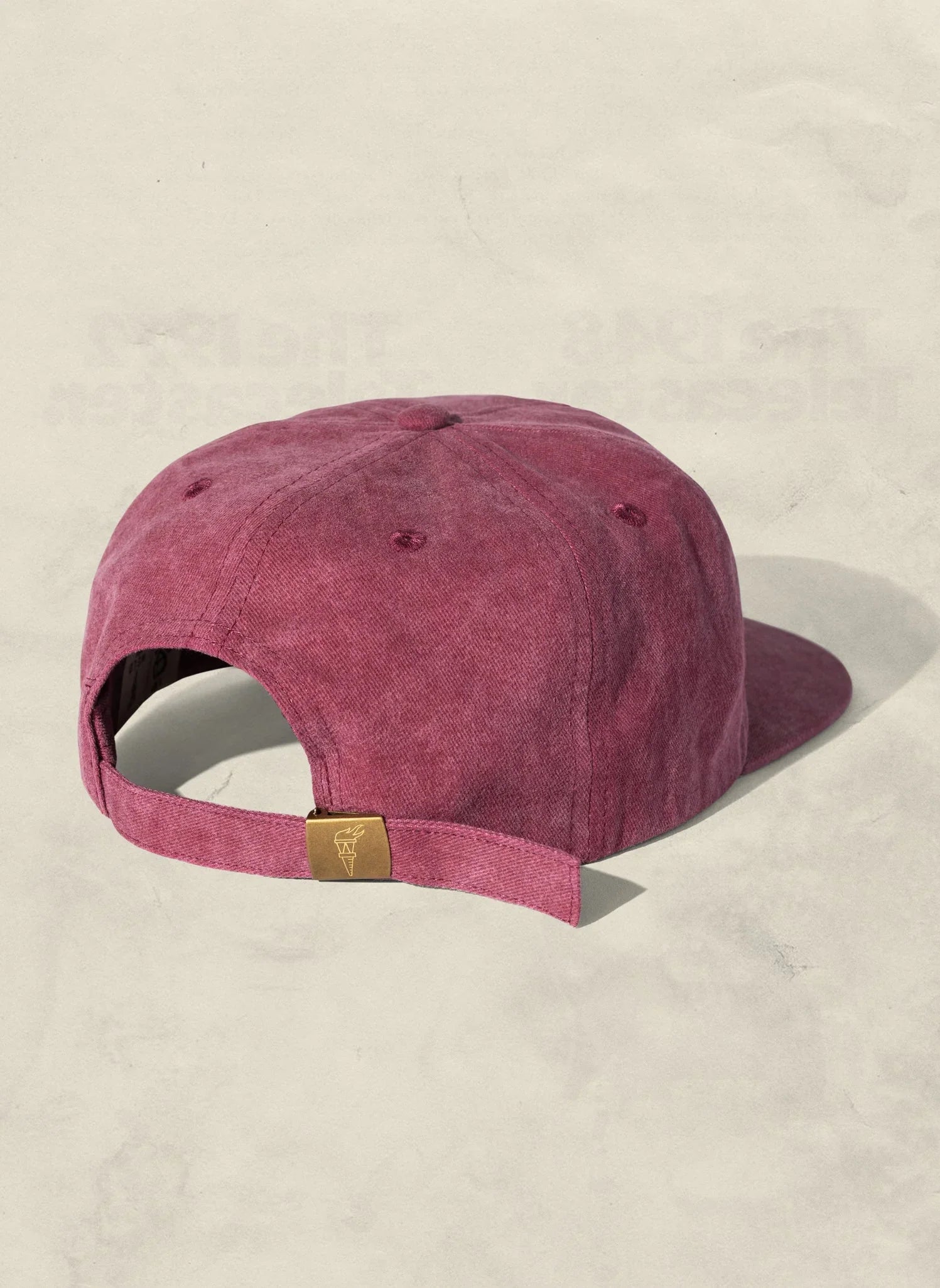 Back view of a maroon suede baseball cap with brass buckle, Qu!rk Boutique accessories