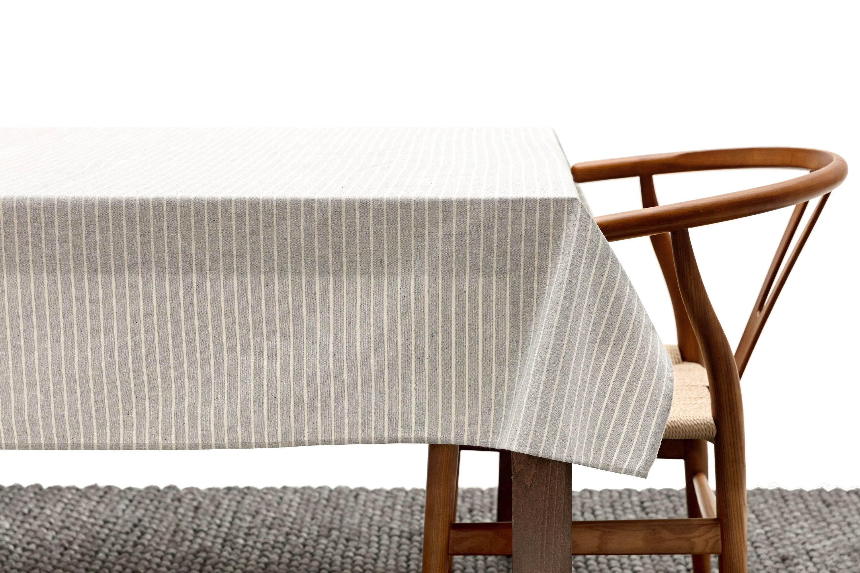 Minimalist striped tablecloth on wooden table with modern wooden chair, Qu!rk Boutique style