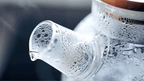 Glass teapot with wood lid steaming, emphasizing cozy, conscious Qu!rk Boutique moments