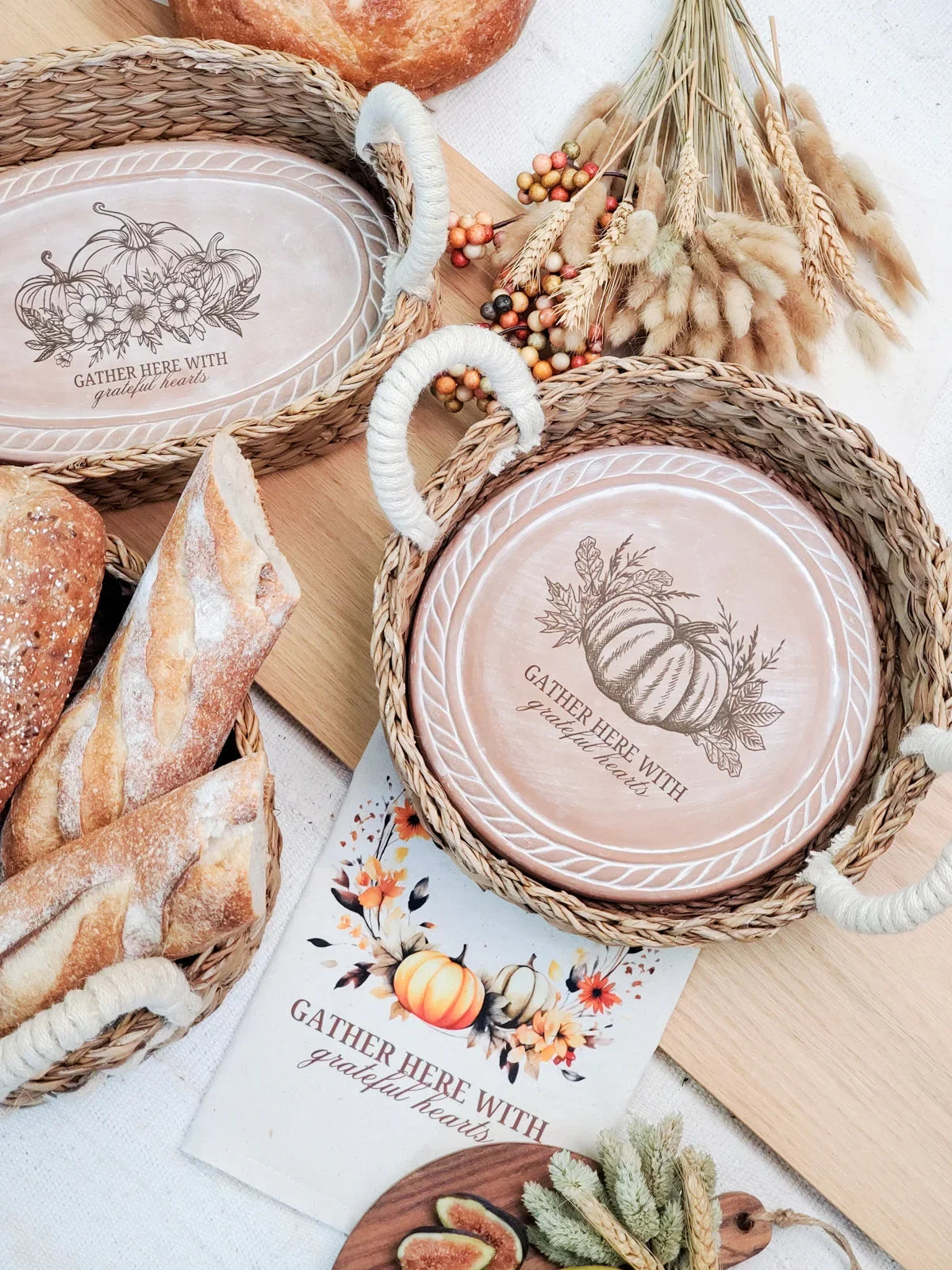 Rustic woven baskets with plates featuring pumpkin designs and 'Gather here with grateful hearts' text, autumn decor
