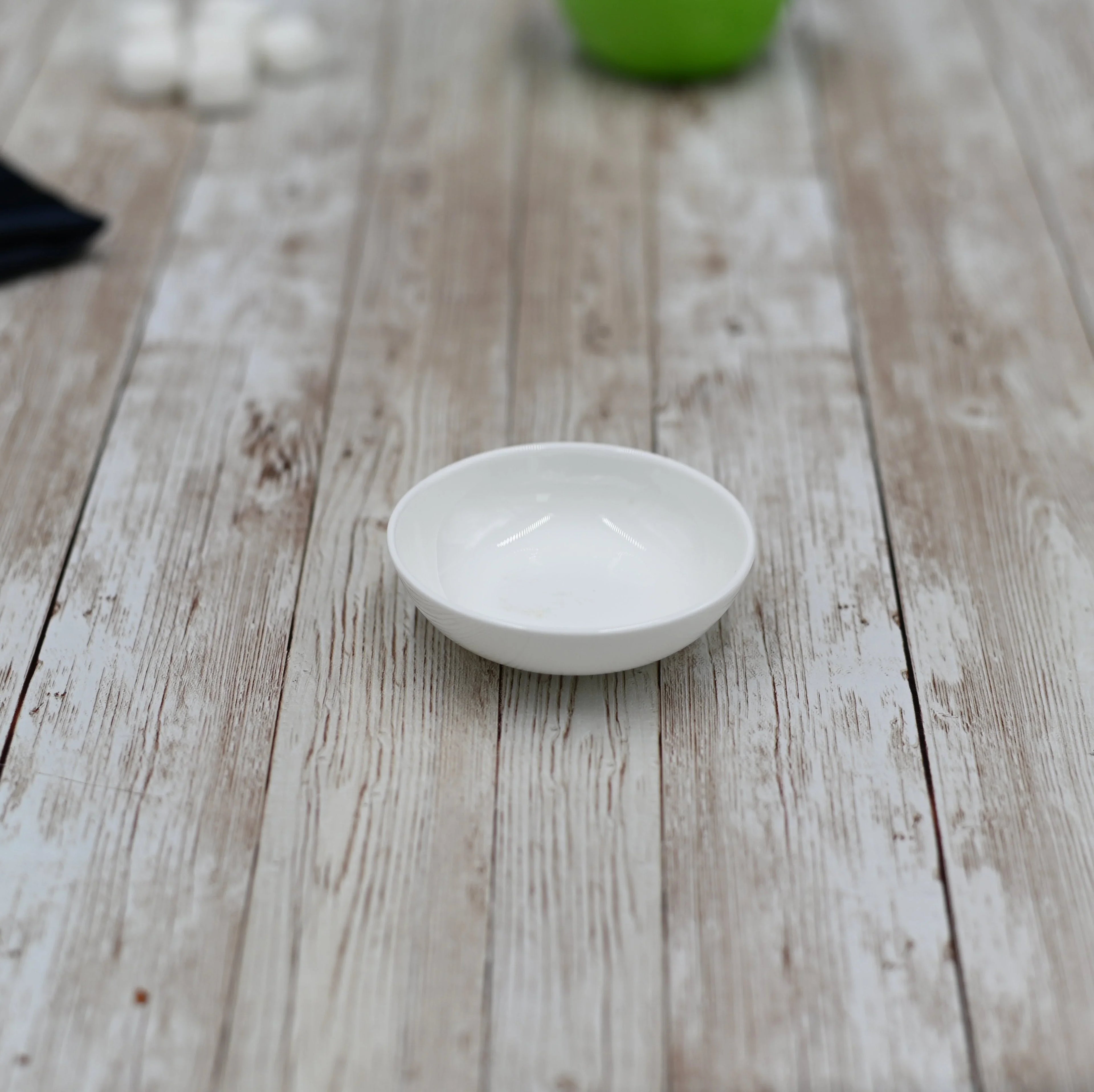 Small white ceramic dish on rustic wood table, Qu!rk Boutique homeware style