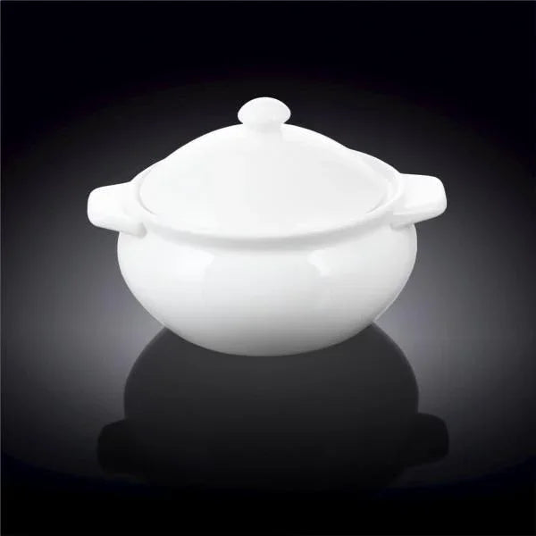 white ceramic casserole dish with lid and side handles on black background
