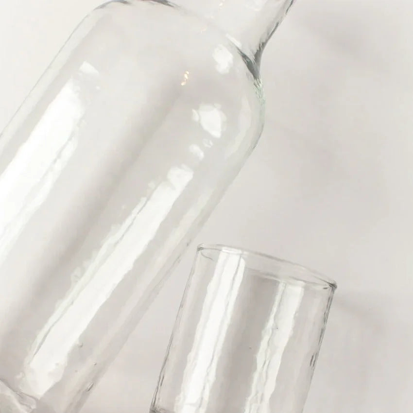 Clear recycled glass carafe and drinking glass on white background at Qu!rk Boutique