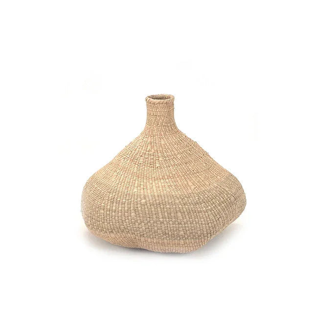 Handwoven natural basket vase with wide base and narrow neck on white background, Qu!rk Boutique