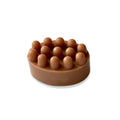 Round brown massage soap bar with raised nodules on top for exfoliation