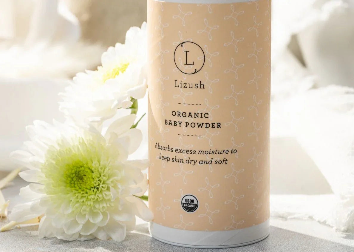 Lizush organic baby powder container with flowers on a light background