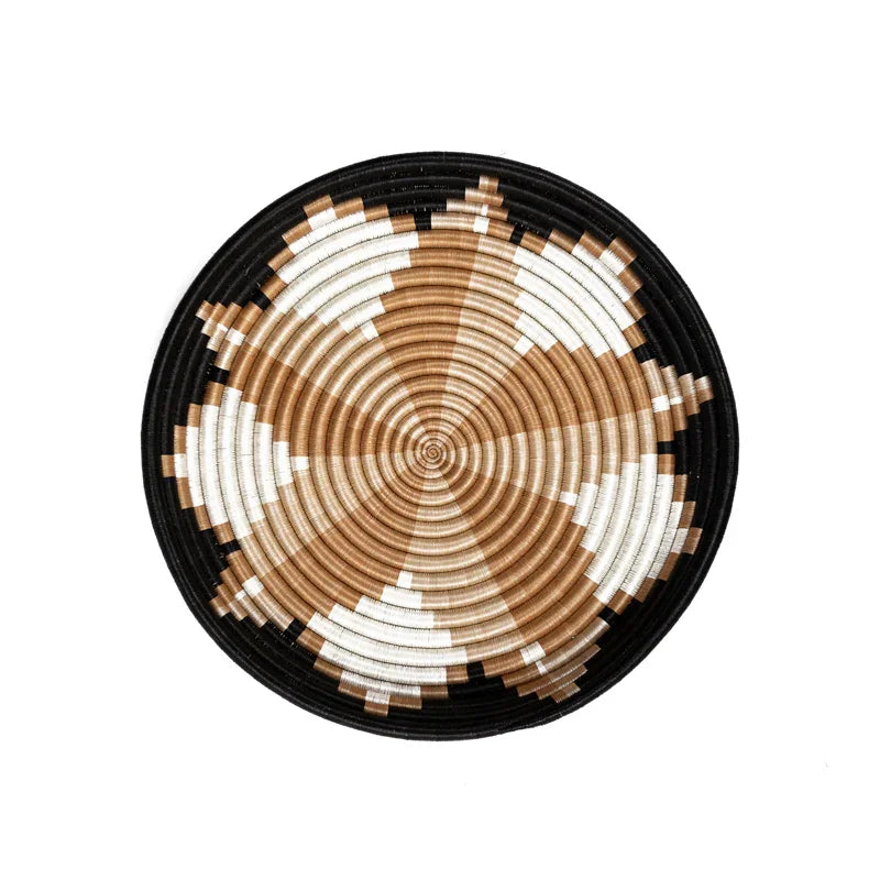 Handwoven decorative bowl with black, tan, and white geometric pattern on white background.