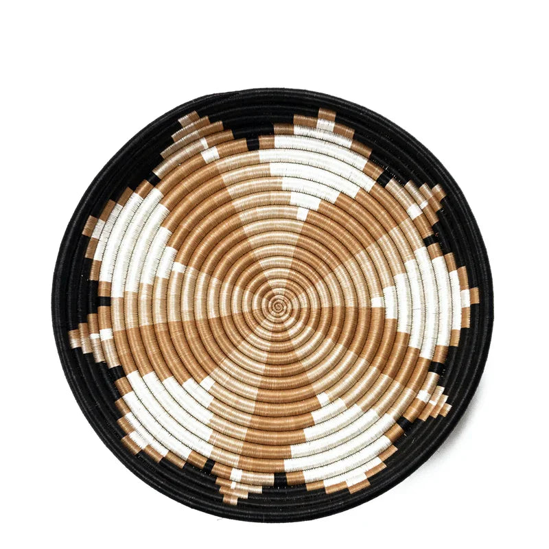 Handwoven bowl with tan, white, and black geometric pattern on white background from Qu!rk Boutique