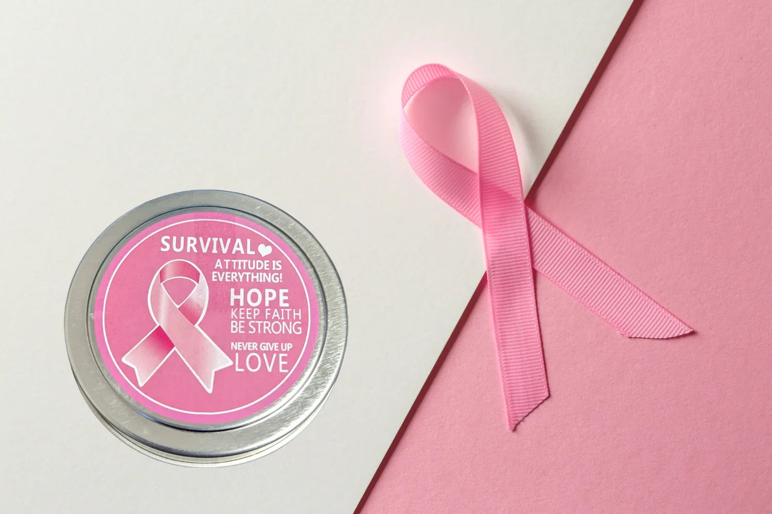 Pink breast cancer awareness ribbon and round tin with survival and hope words on pink and white background