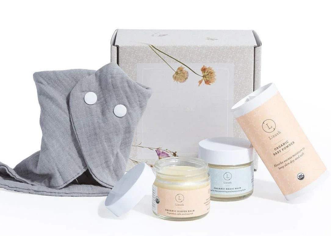 Organic baby care set with diaper balm, magic balm, baby powder, and grey cloth wrap