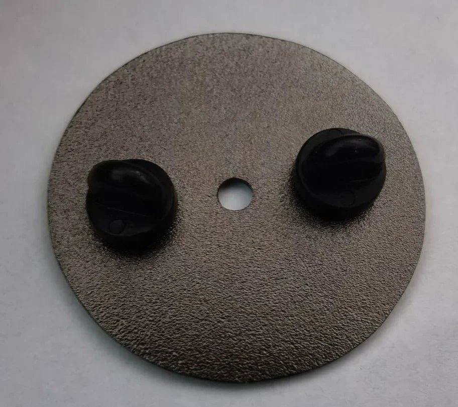 Metal backing plate with two black rubber knobs and a centered hole on a white background