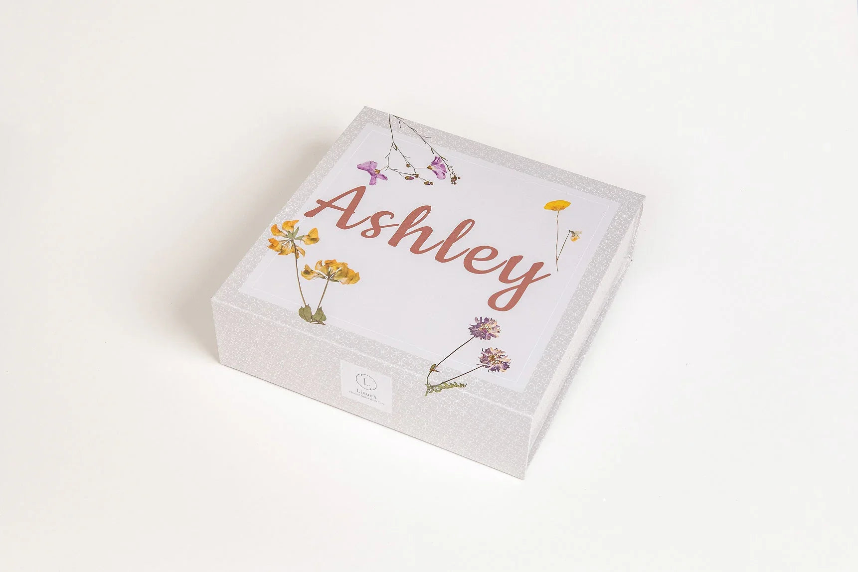 Personalized gray gift box with Ashley name and floral design on white background