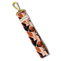 Floral patterned fabric wristlet keychain with brass clip and Slow North label