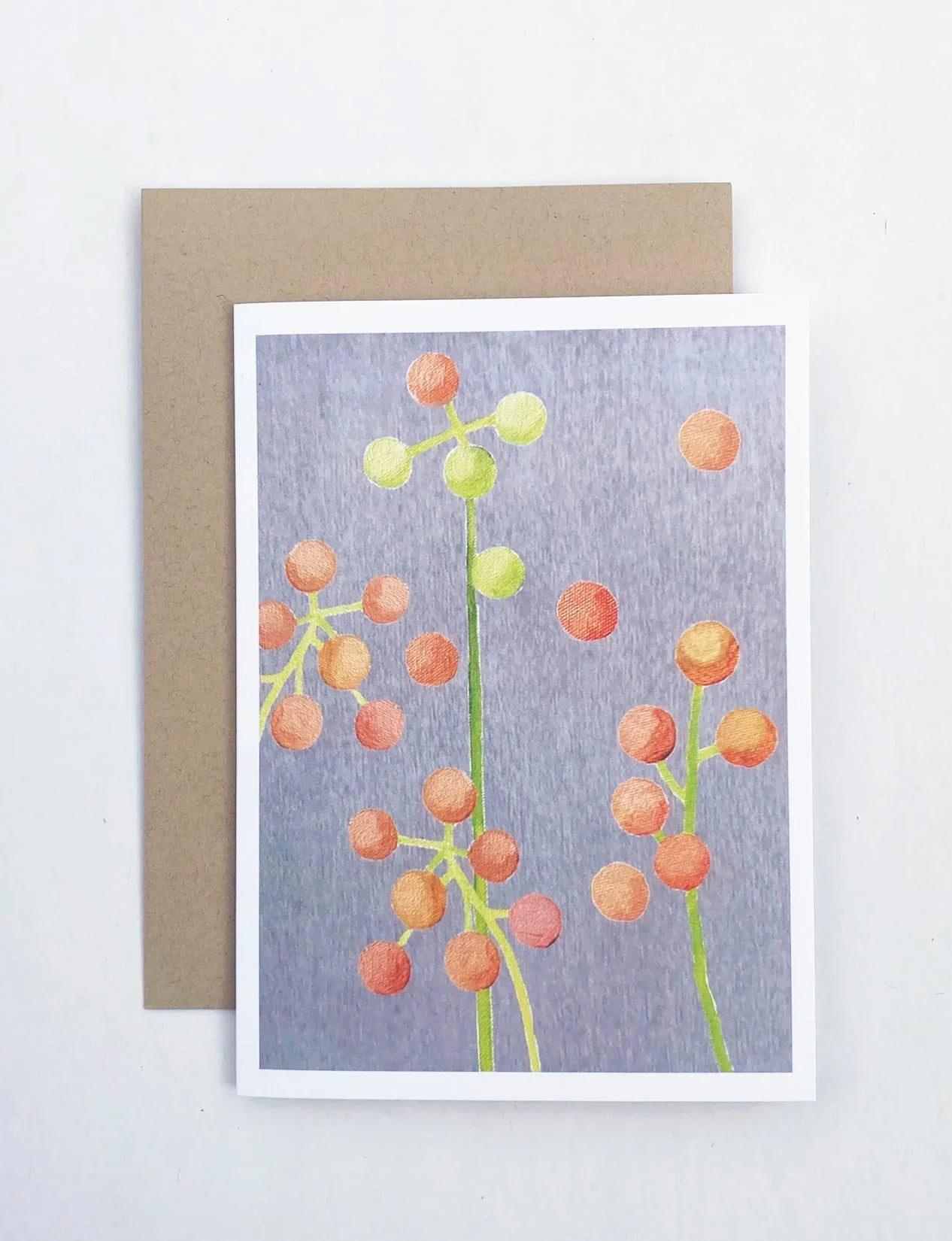 Brunia floral notecard with orange and green berries illustration on gray background and kraft envelope