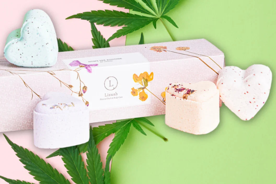 Lizush herbal bath and body care set with heart-shaped and round bath bombs on pink and green background with cannabis leaves