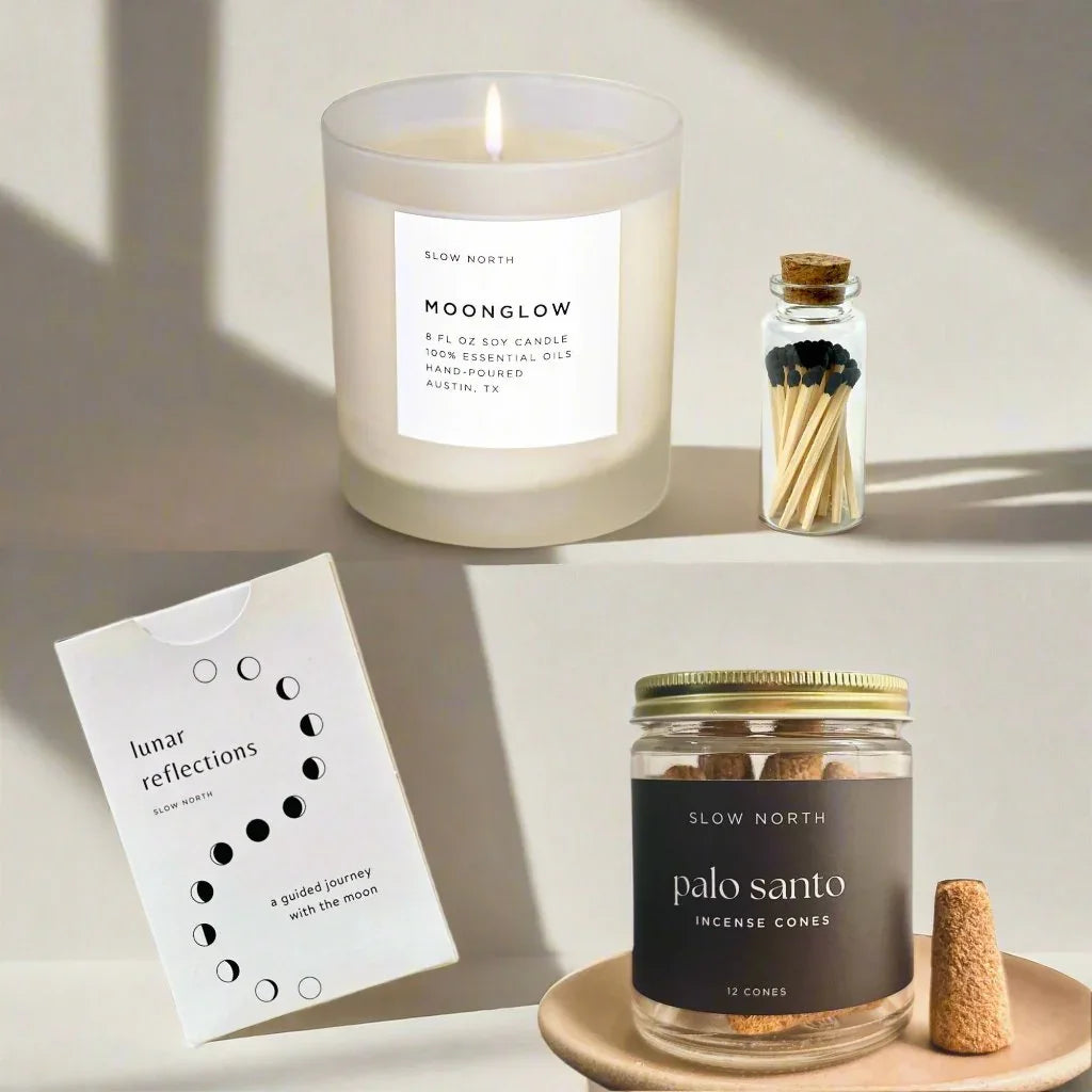 Slow North Moonglow soy candle, glass jar with palo santo incense cones, matches in bottle, and lunar reflections card